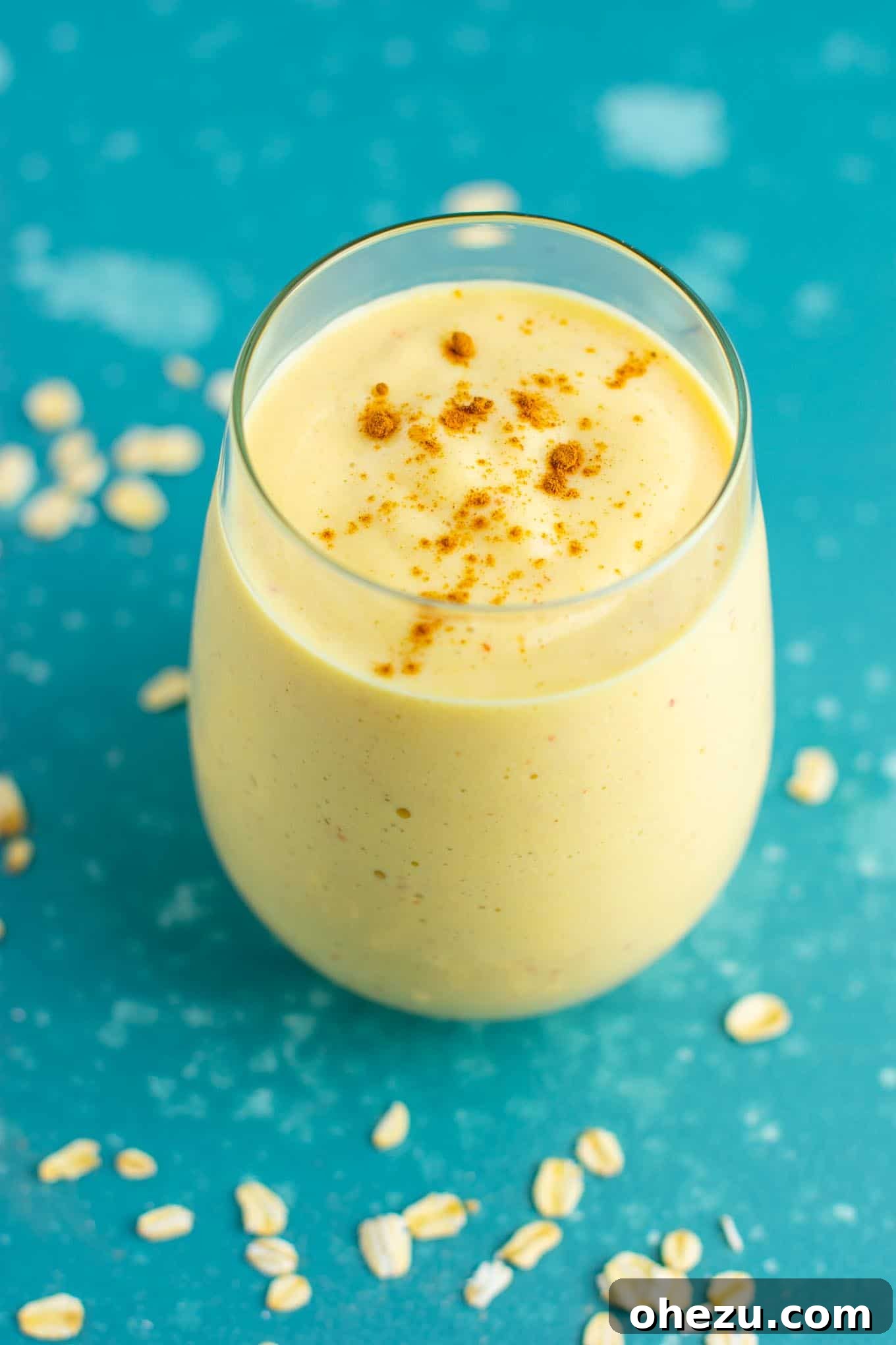 Mastering Homemade Smoothies 4 a healthy peach smoothie in a clear glass, garnished with a sprinkle of cinnamon, showcasing a creamy texture