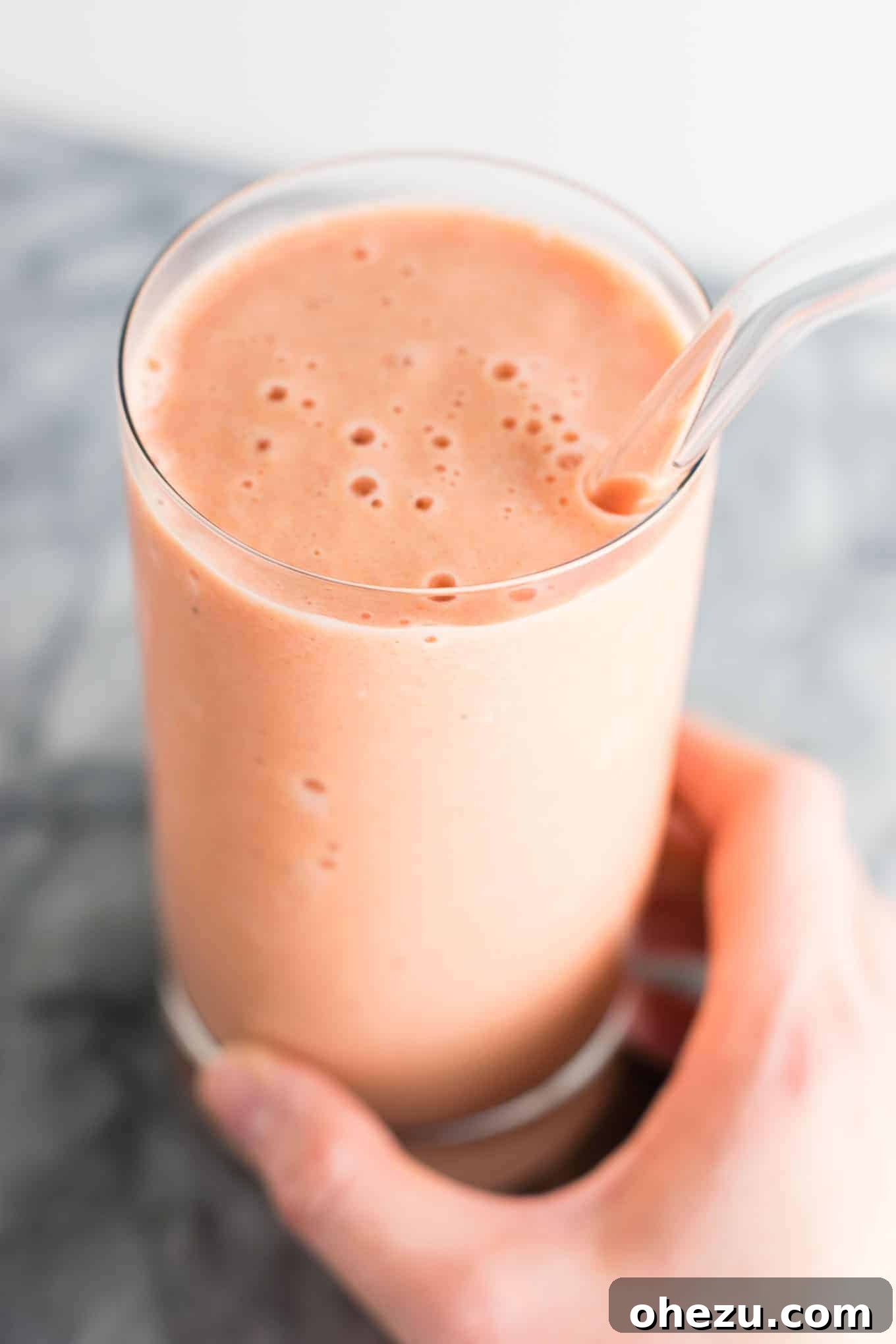 Mastering Homemade Smoothies 8 a carrot cake smoothie served in a glass with a glass straw, garnished to evoke the flavors of carrot cake