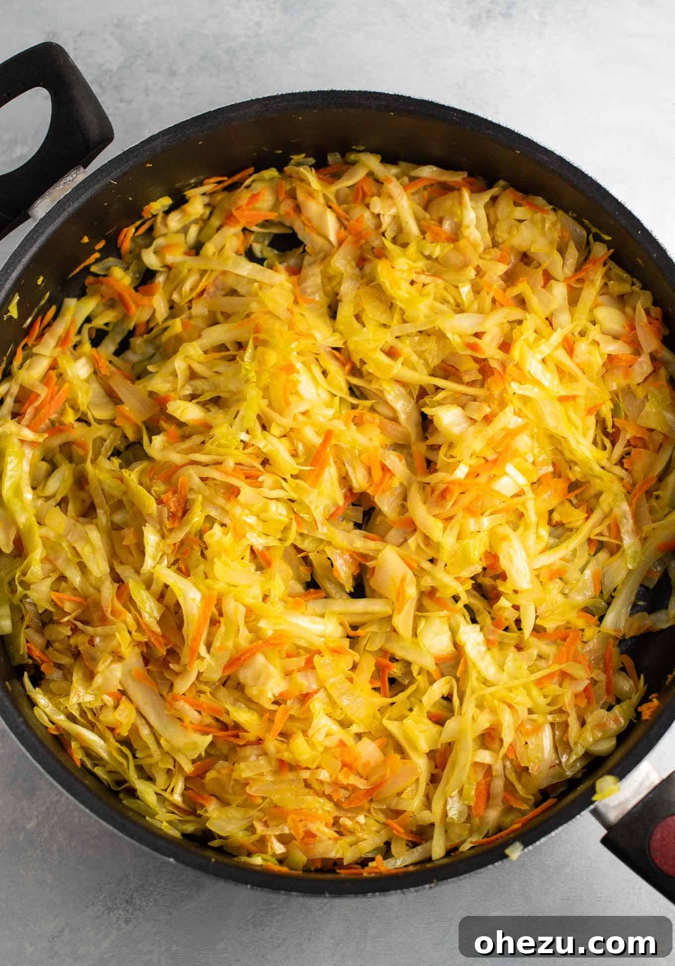 The cooked cabbage, carrots, ginger, and onion, perfectly wilted and ready for the next steps.