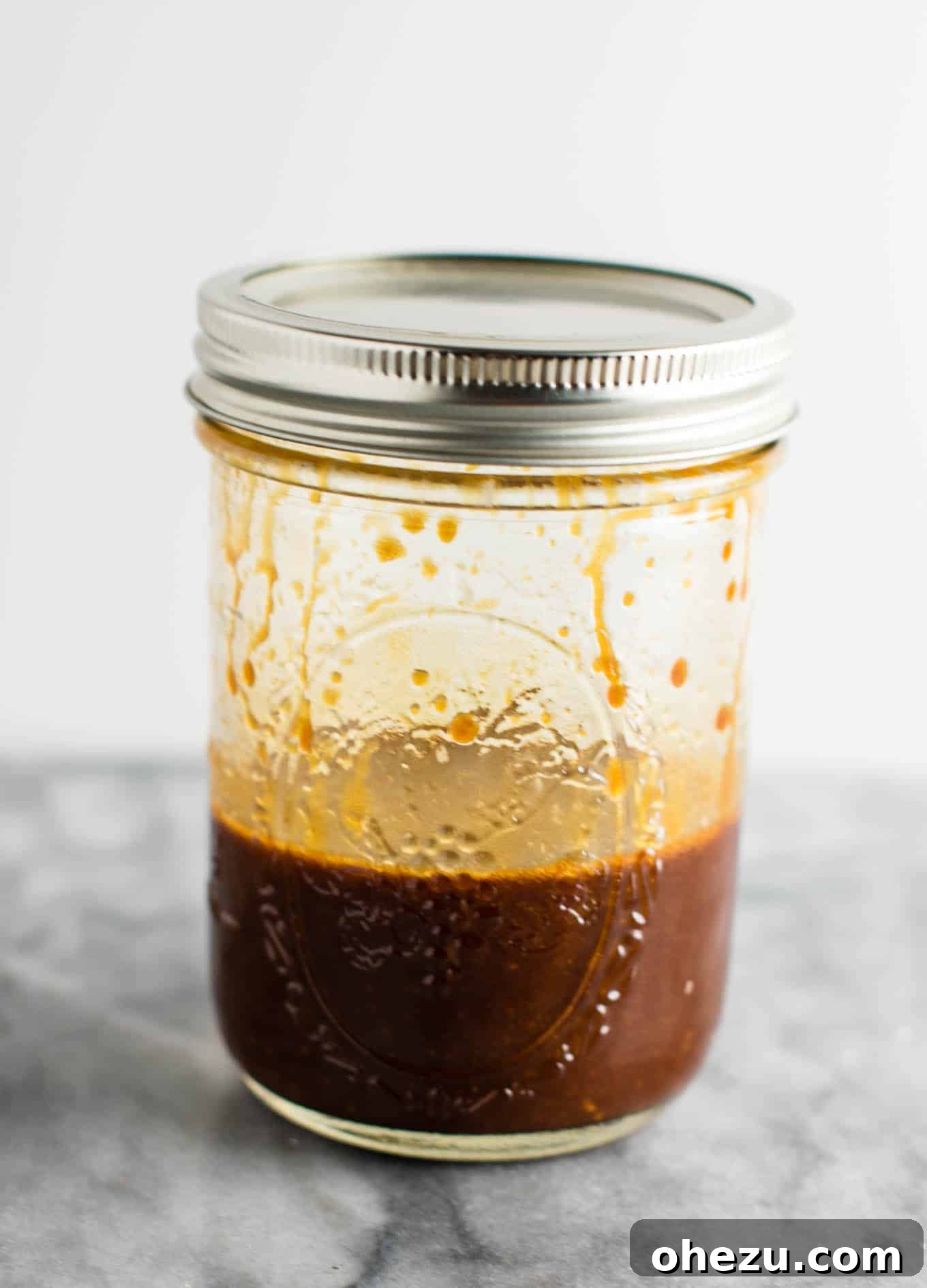 A mason jar filled with the homemade 3-ingredient stir fry sauce, ready to be added to the dish.