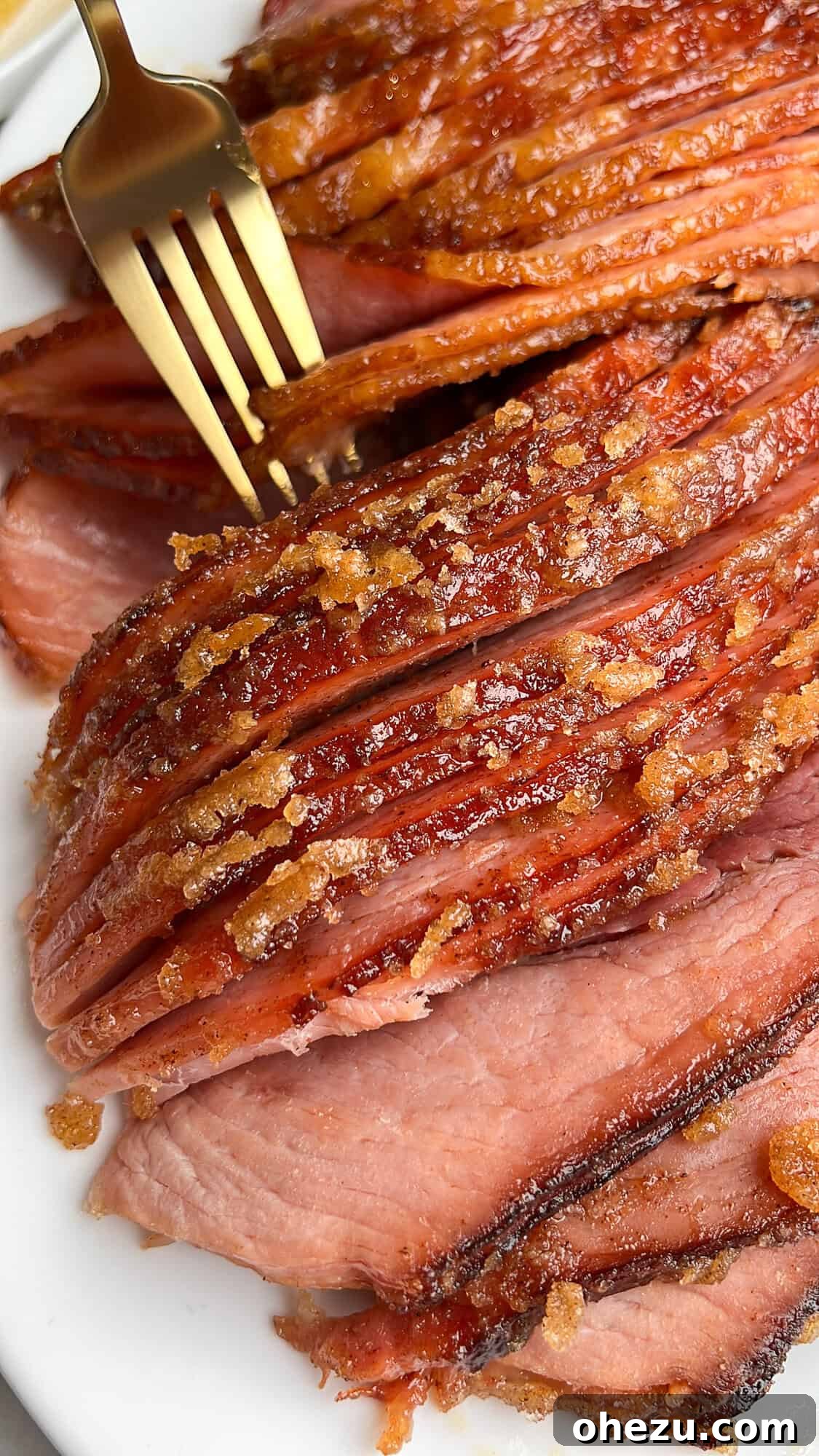 Tender Honey Glazed Slow Cooker Ham 2 slow cooker ham with a candy crust sitting on a plate