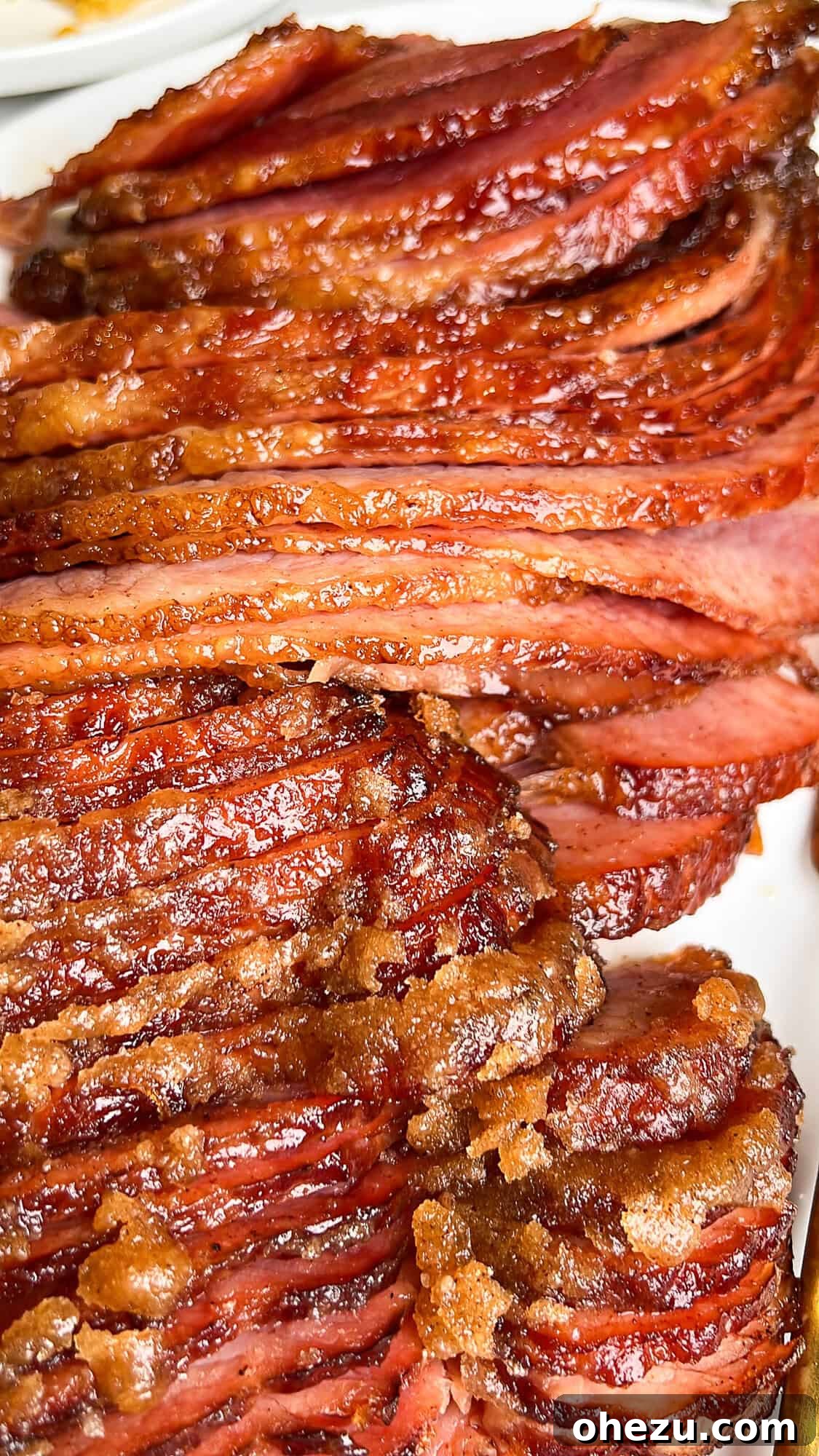 Tender Honey Glazed Slow Cooker Ham 4 honey baked ham on a plate sliced