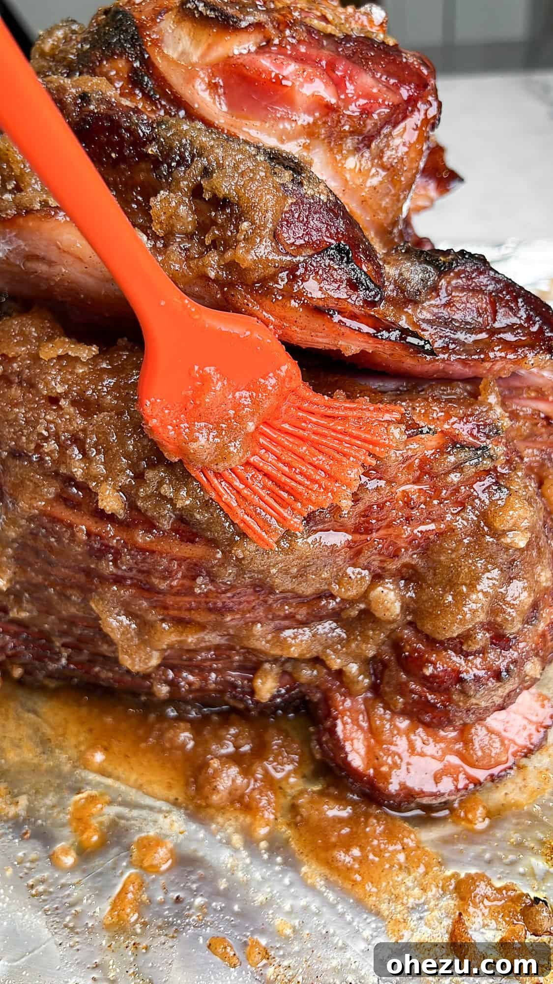 Tender Honey Glazed Slow Cooker Ham 9 rubbing in the sugar coating glaze on the ham with a basting brush