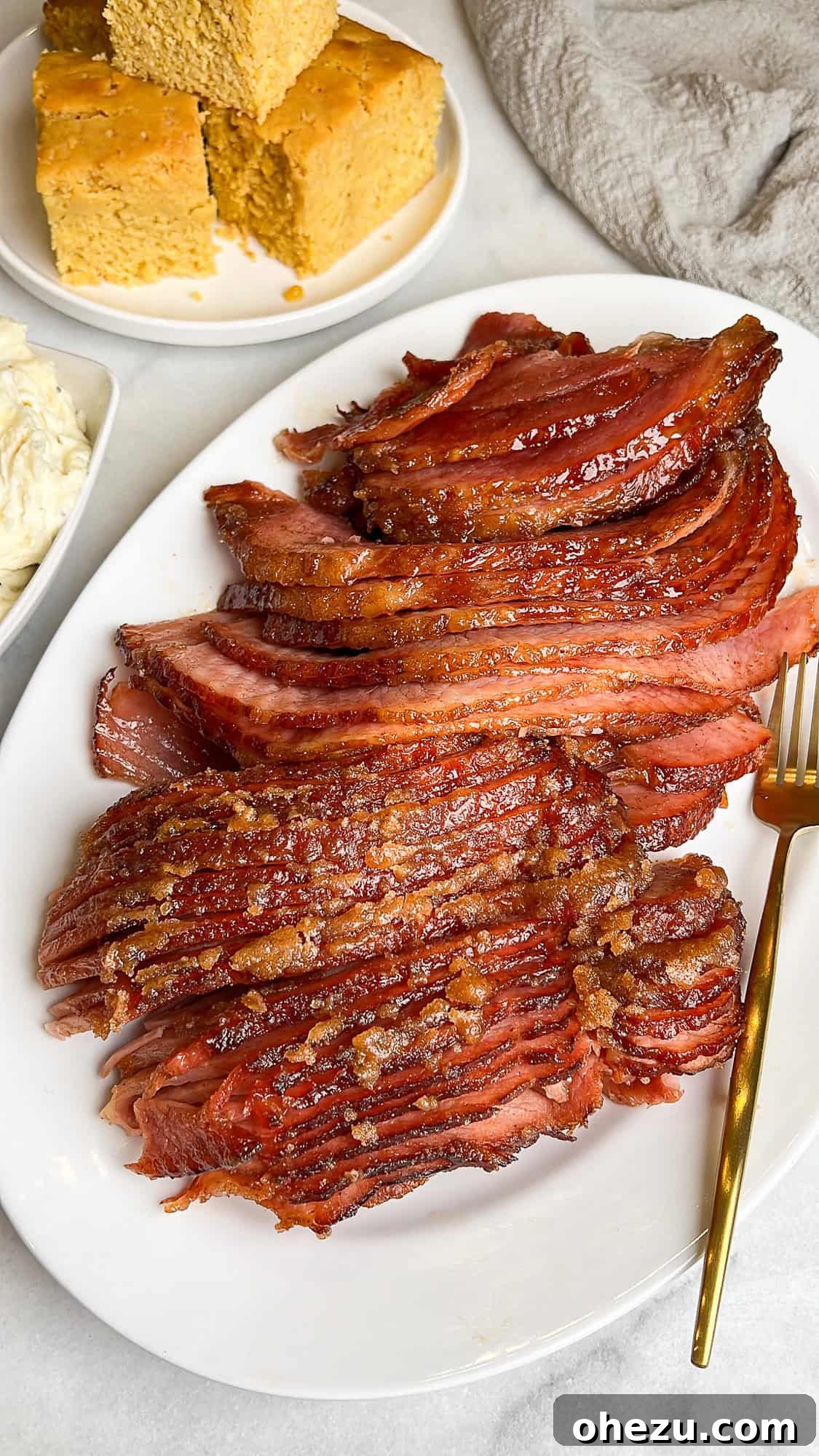 Tender Honey Glazed Slow Cooker Ham 10 sliced ham on a serving platter on a thanksgiving table