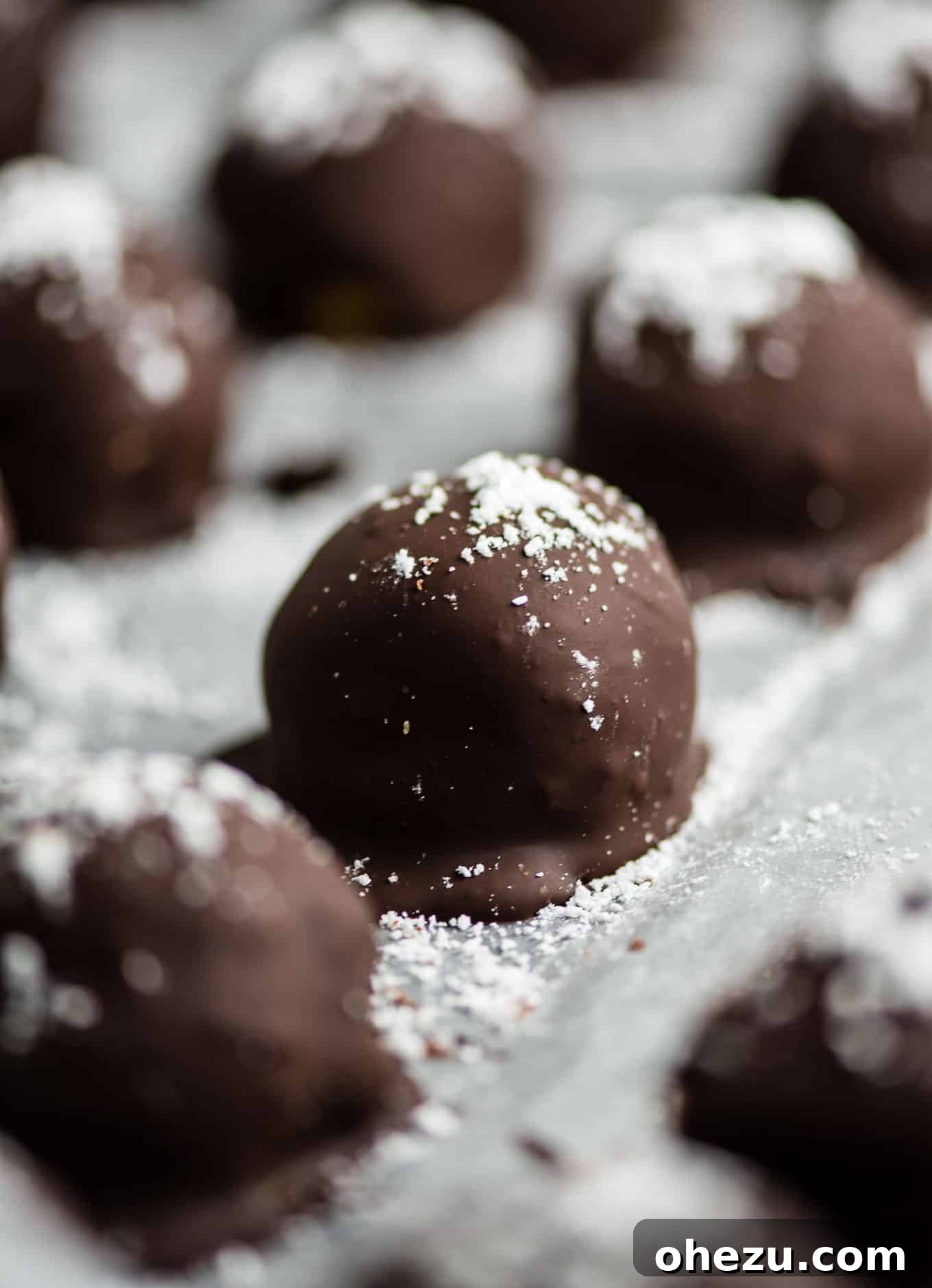 Collection of pumpkin cheesecake truffles on a white background, perfect for fall desserts