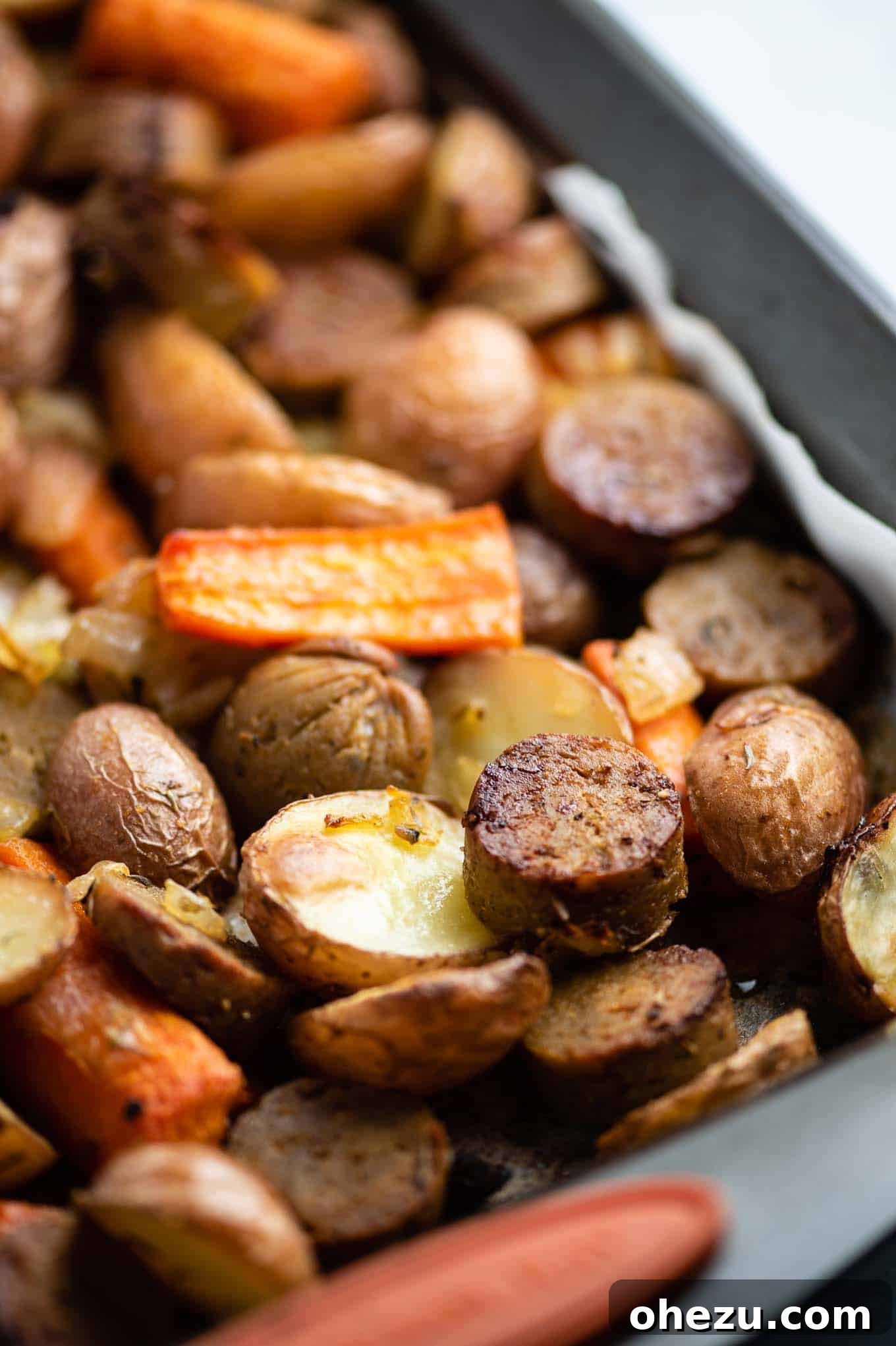 Close-up shot of perfectly roasted vegetarian kielbasa and potato, showcasing golden-brown edges and tender texture.