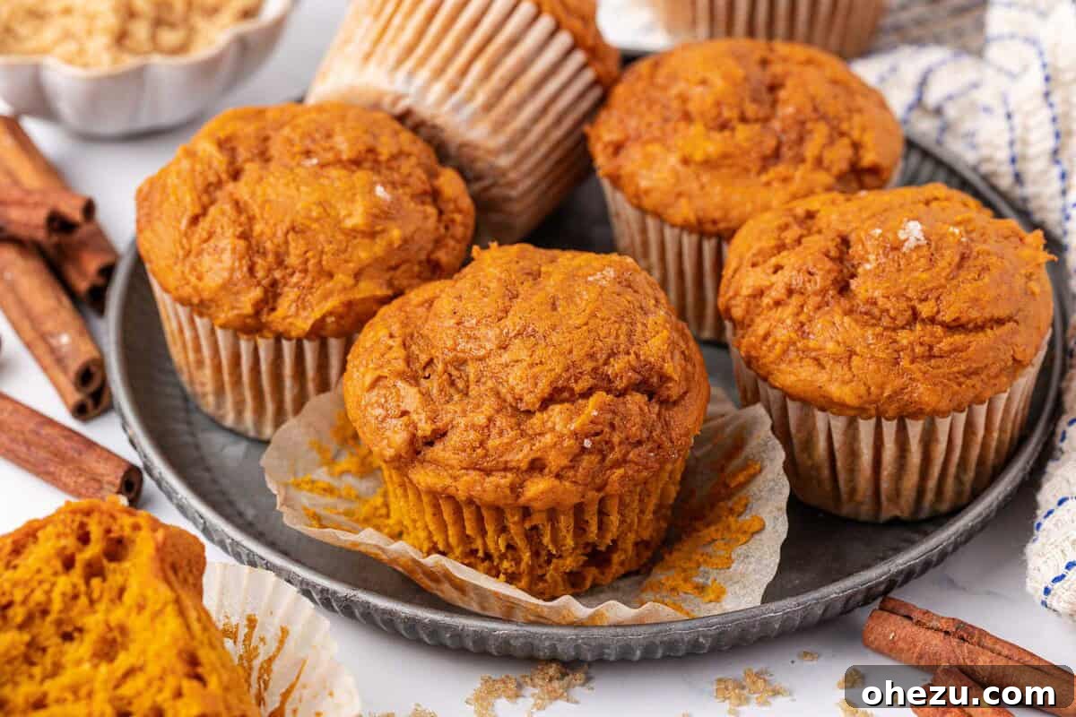 A tray of freshly baked Cake Mix Pumpkin Muffins cooling, ready to be enjoyed as an easy fall treat