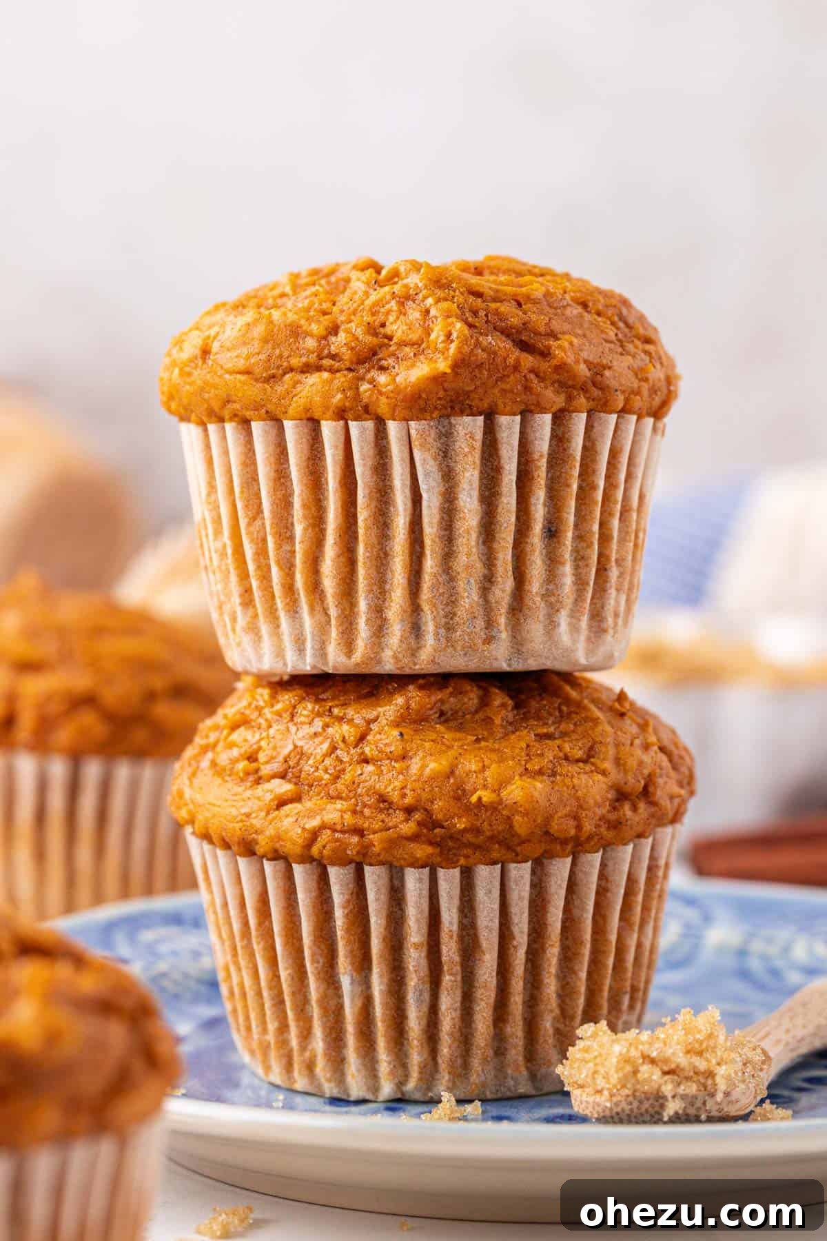 A stack of golden brown cake mix pumpkin muffins on a wooden board, ready to be served or stored