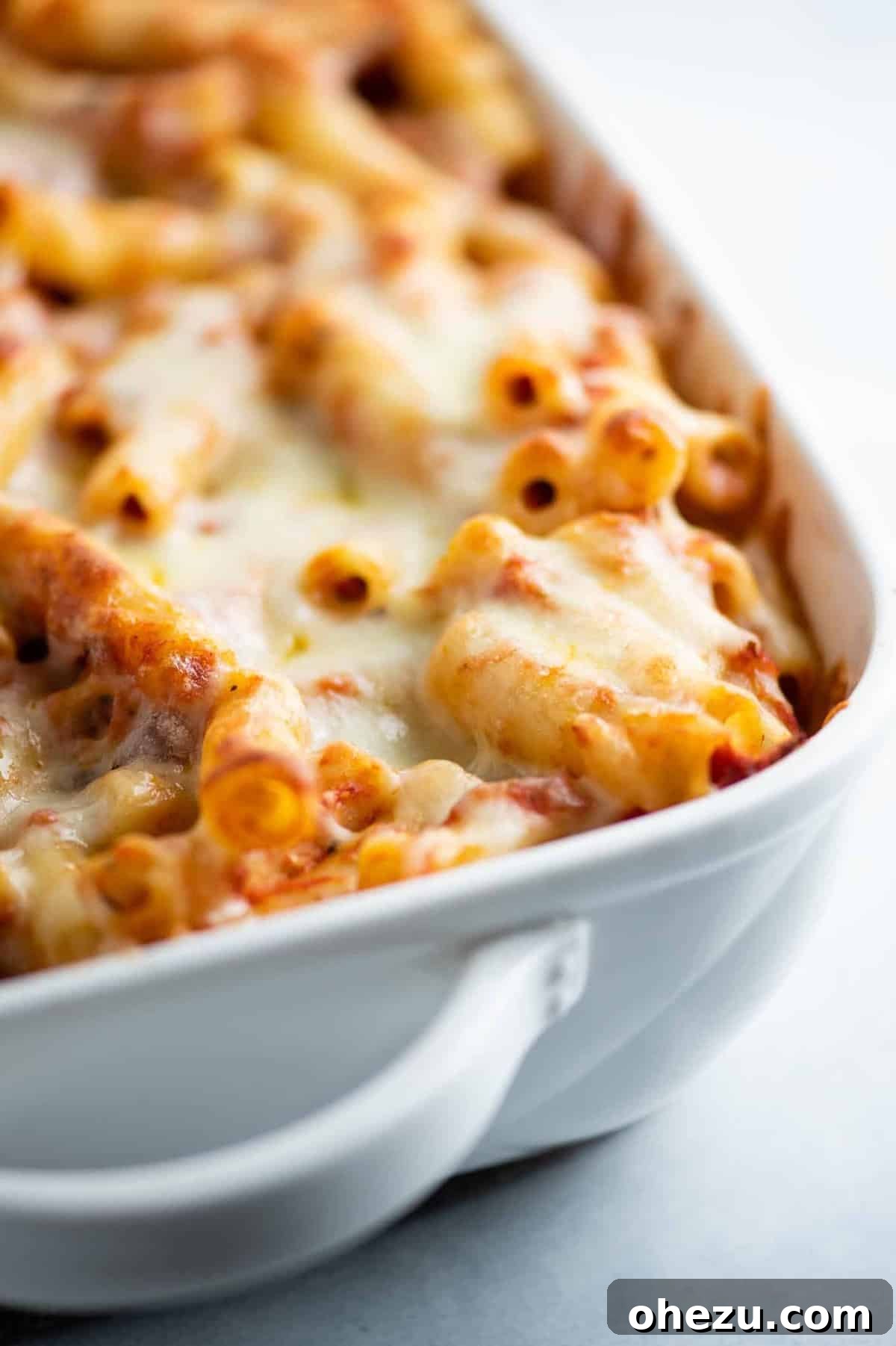 baked ziti in a white casserole dish, ready to be served