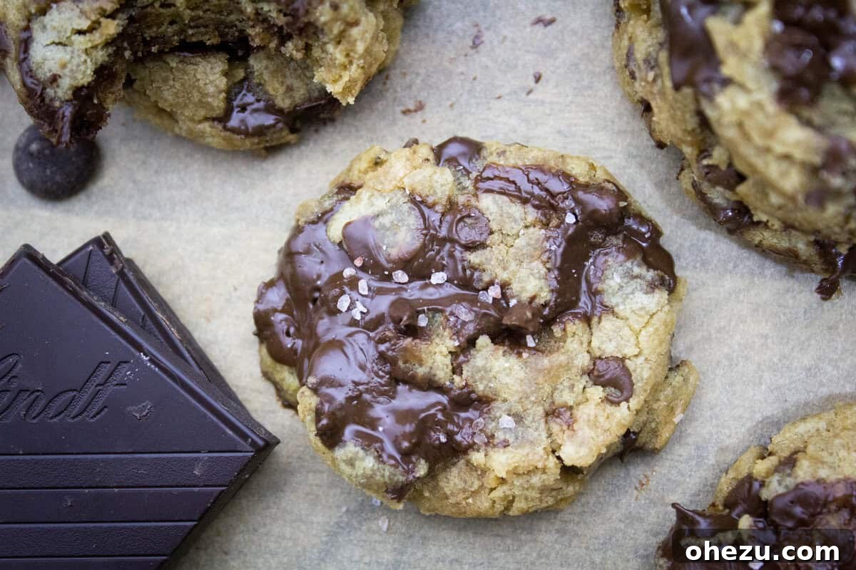Signature Golden Butter Chewy Chocolate Chip Cookies 5 Freshly baked chewy chocolate chip cookies cooling on a wire rack, perfectly sprinkled with flaky sea salt