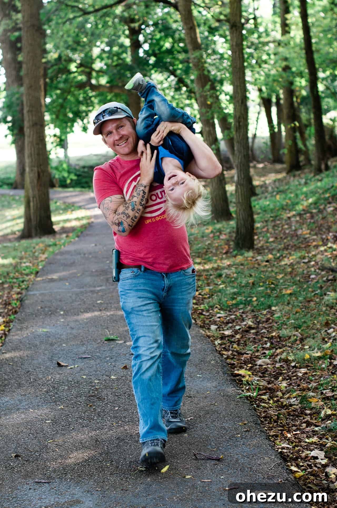 My Five-Year Food Blogging Journey 3 a dad holding his toddler upside down while walking
