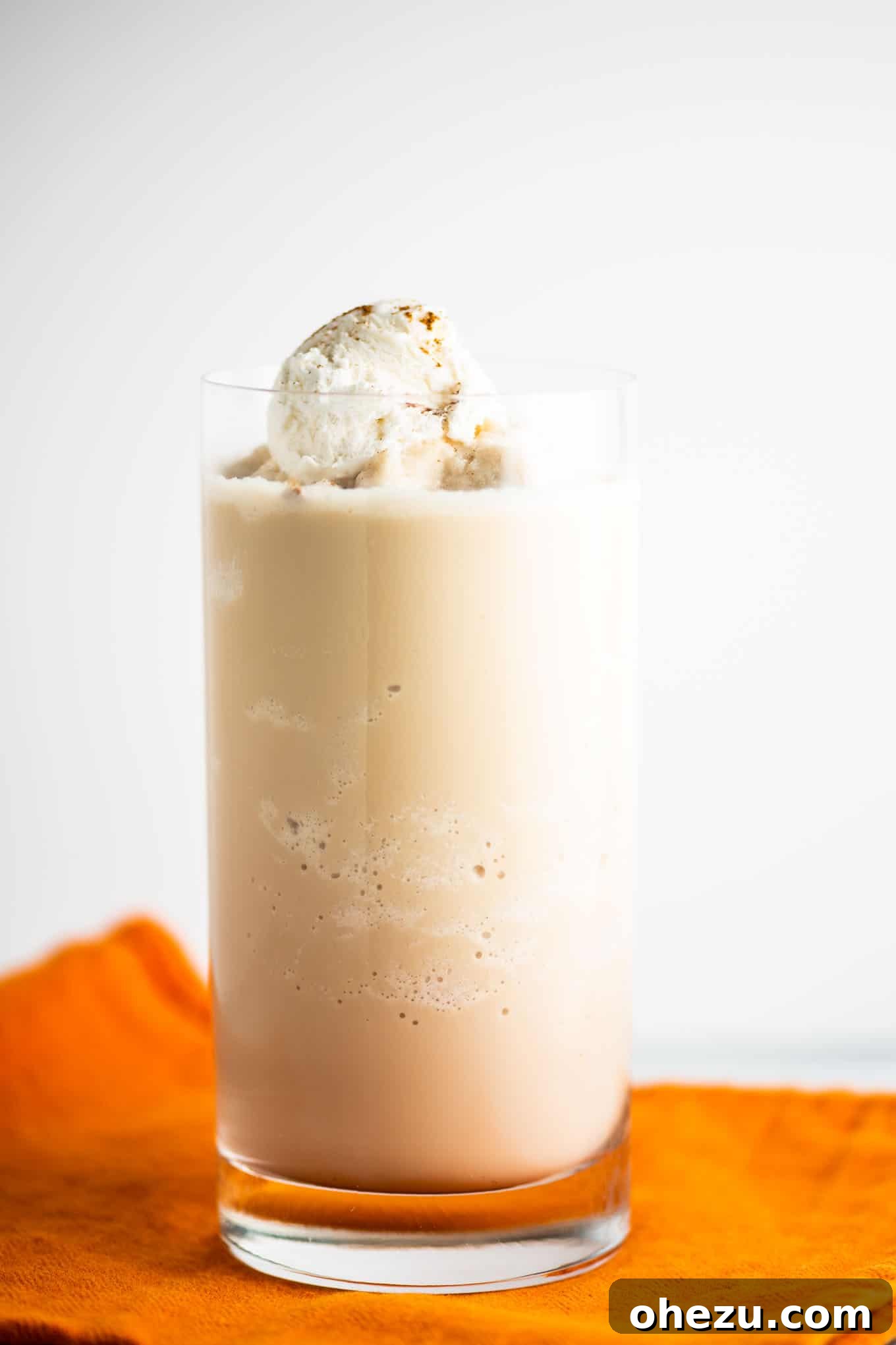 Chilled Pumpkin Dream 5 pumpkin spice frozen coffee in a clear tall glass, topped with whipped cream