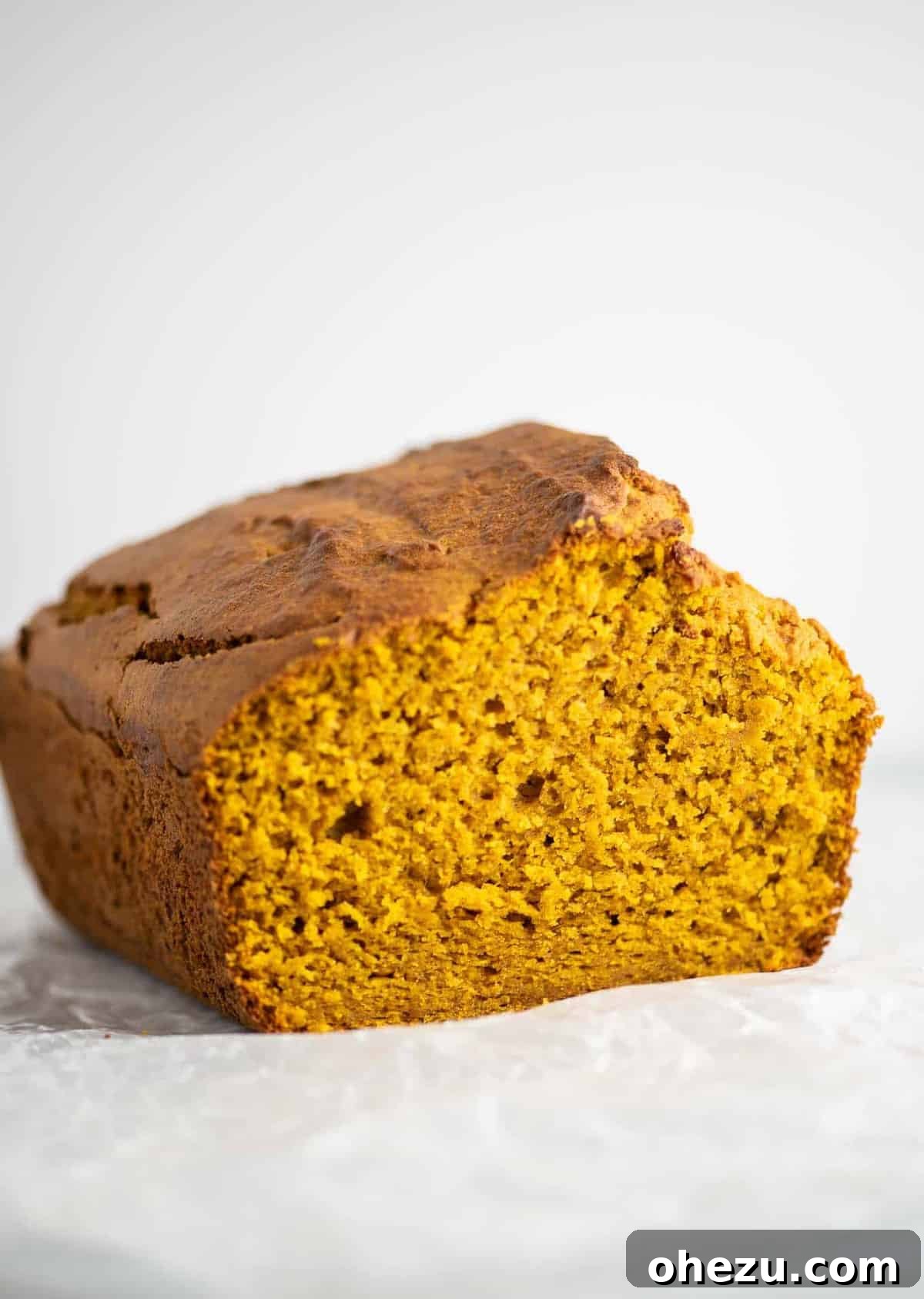 A glorious loaf of cake mix pumpkin bread cooling on a wire rack.