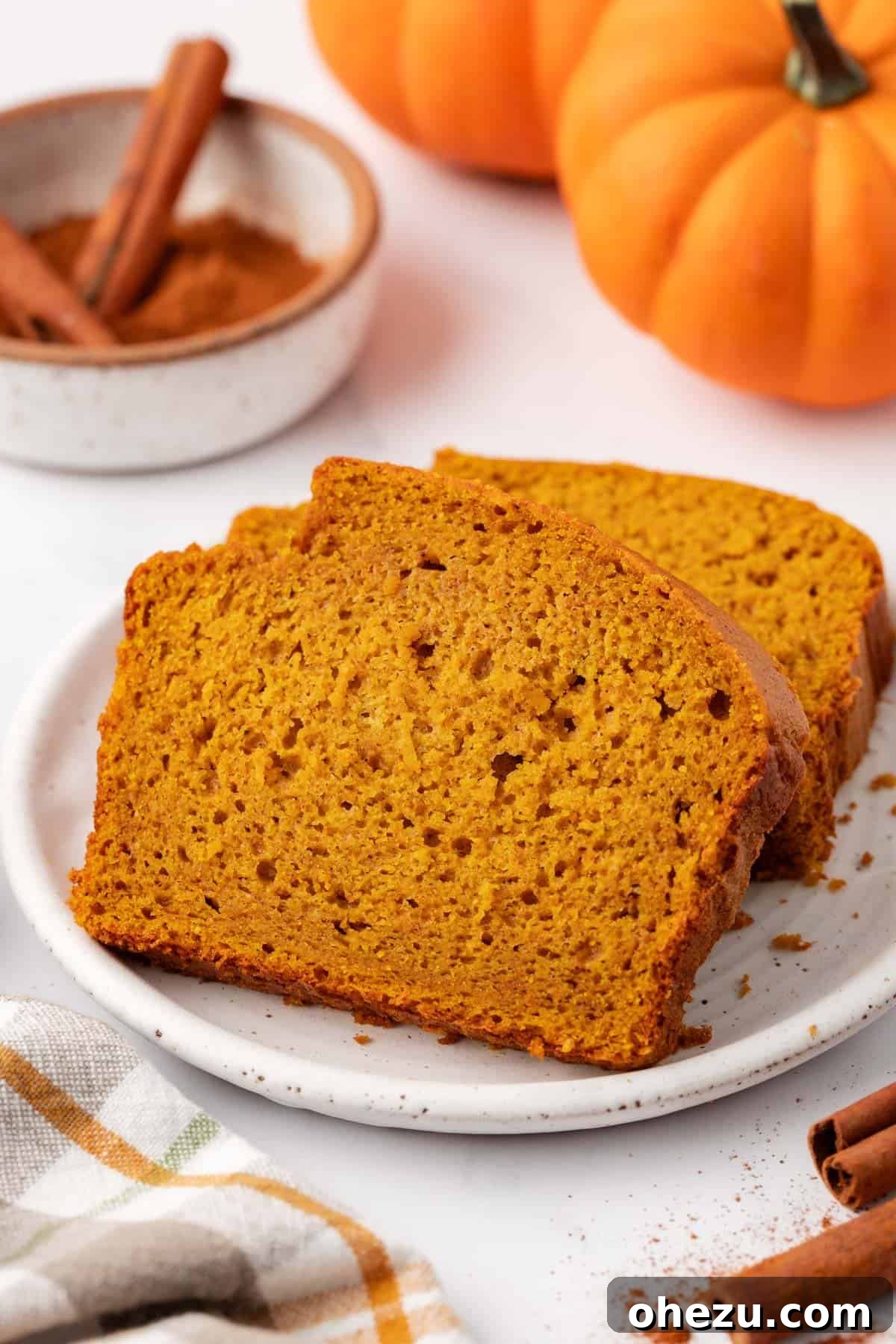 Perfectly baked slices of cake mix pumpkin bread arranged on a plate.