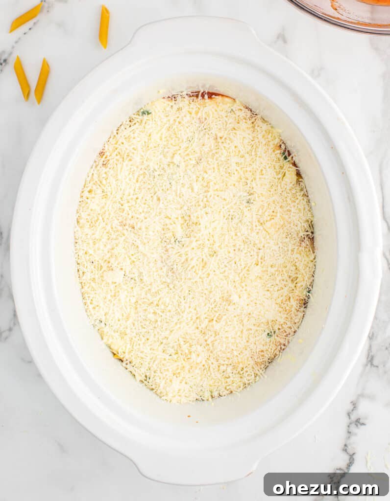 Effortless Slow Cooker Baked Ziti 14 Parmesan cheese generously sprinkled over the last ricotta layer.
