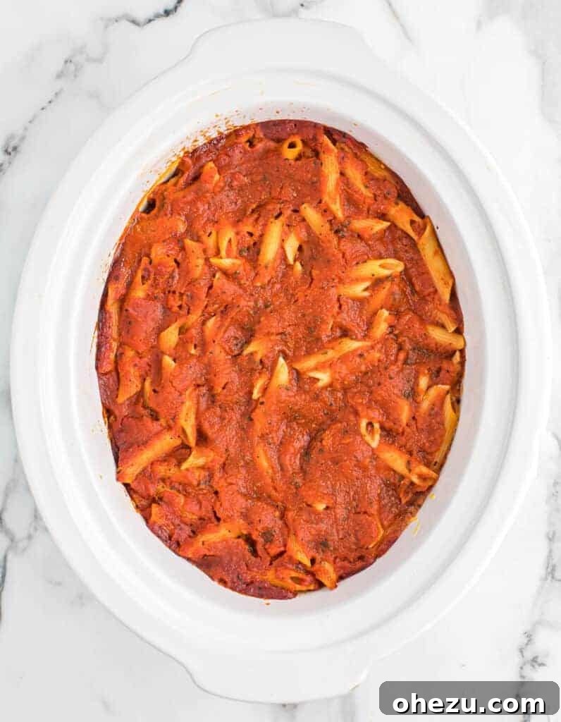 Effortless Slow Cooker Baked Ziti 17 The fully cooked crock pot baked ziti, simmering gently before the final cheese topping is added.