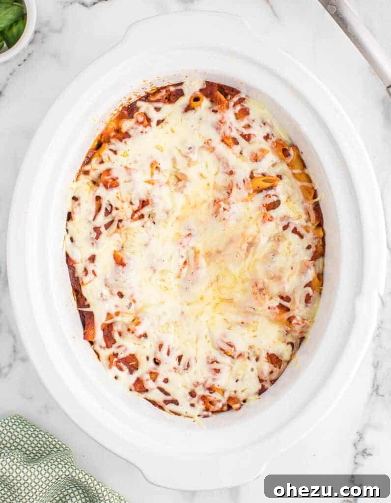 Effortless Slow Cooker Baked Ziti 18 A close-up view of the rich, cooked baked ziti, showing tender noodles bathed in sauce.