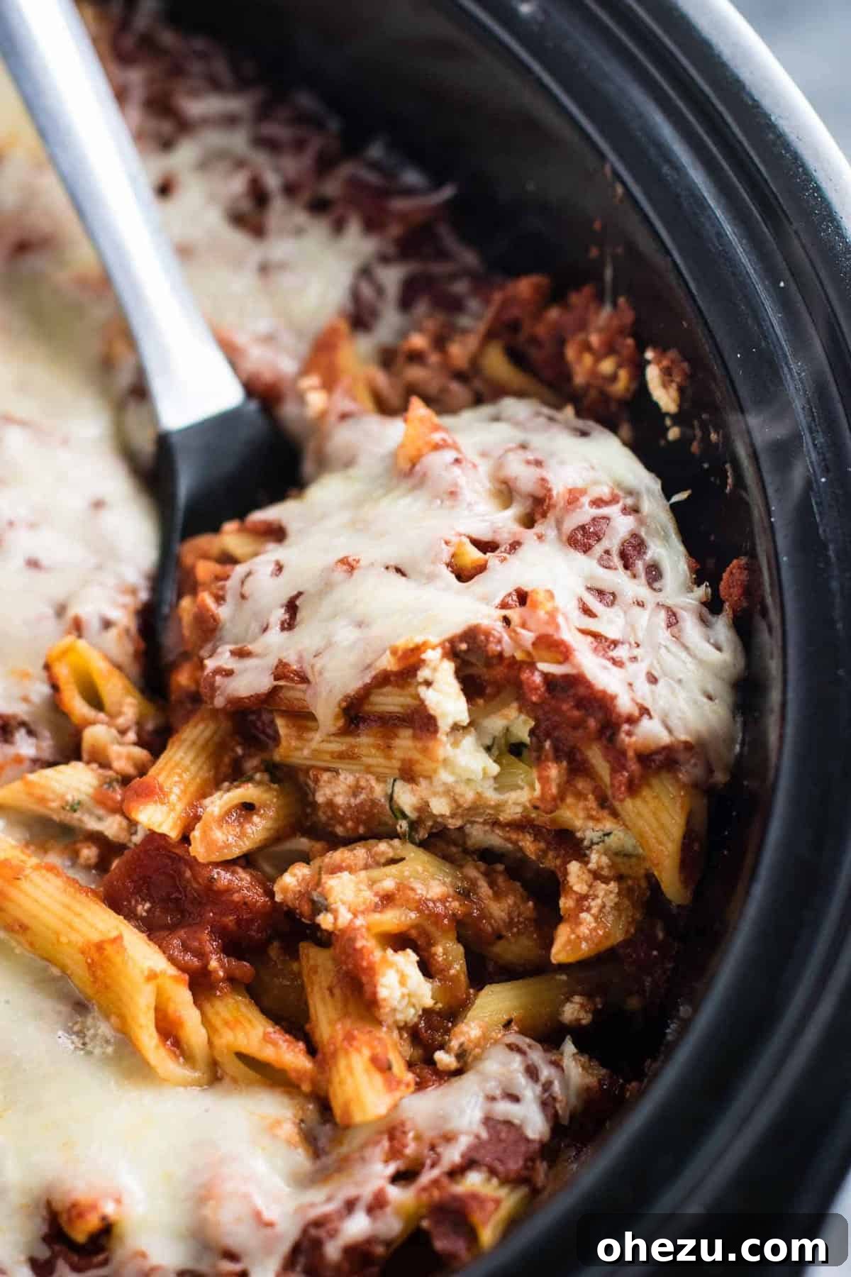Effortless Slow Cooker Baked Ziti 19 A magnificent serving of golden, cheesy crock pot baked ziti, garnished and ready for the table.