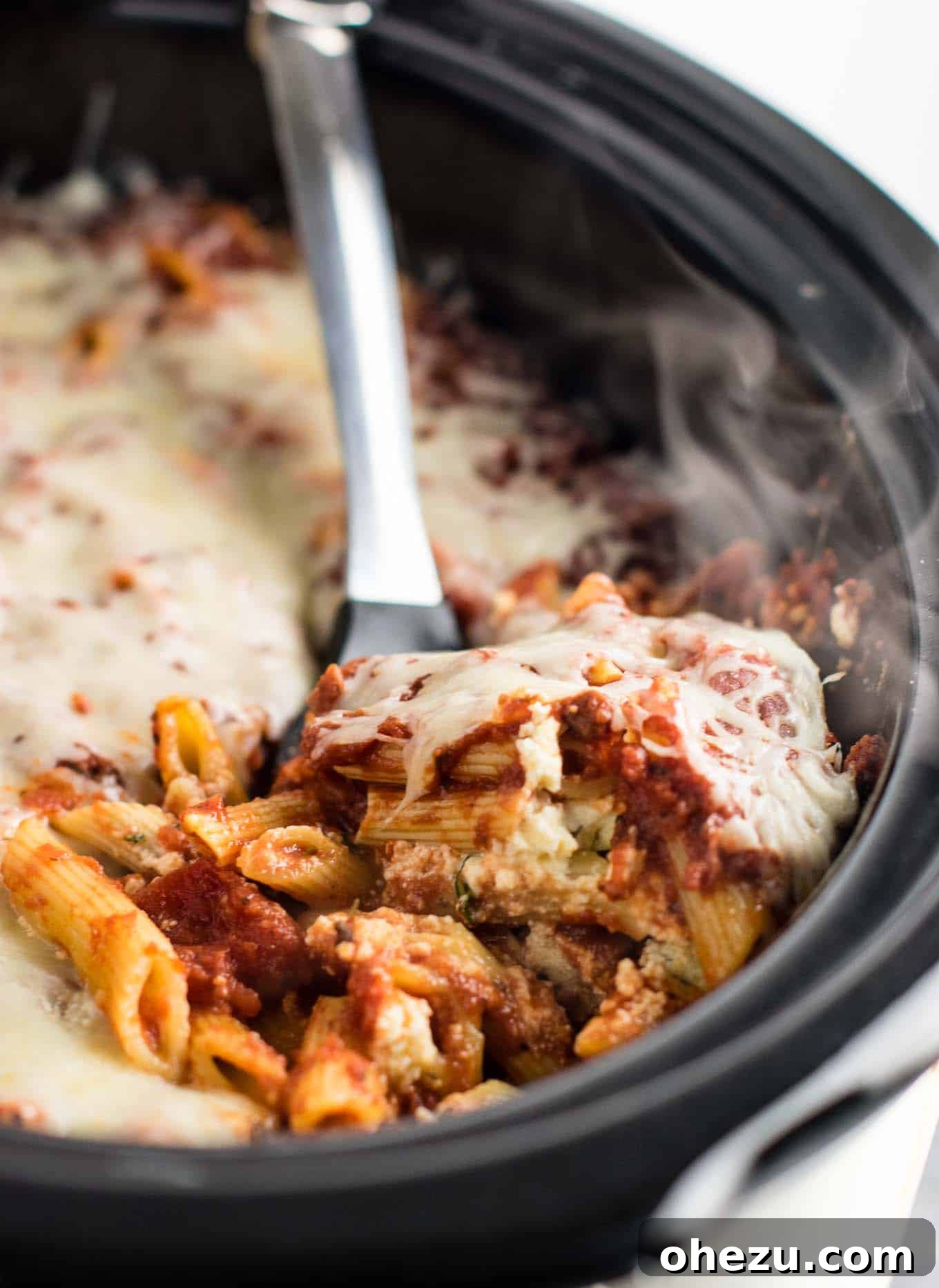 Effortless Slow Cooker Baked Ziti 20 A generous portion of Crock Pot Baked Ziti displaying its layers of pasta, sauce, and beautifully melted cheese.