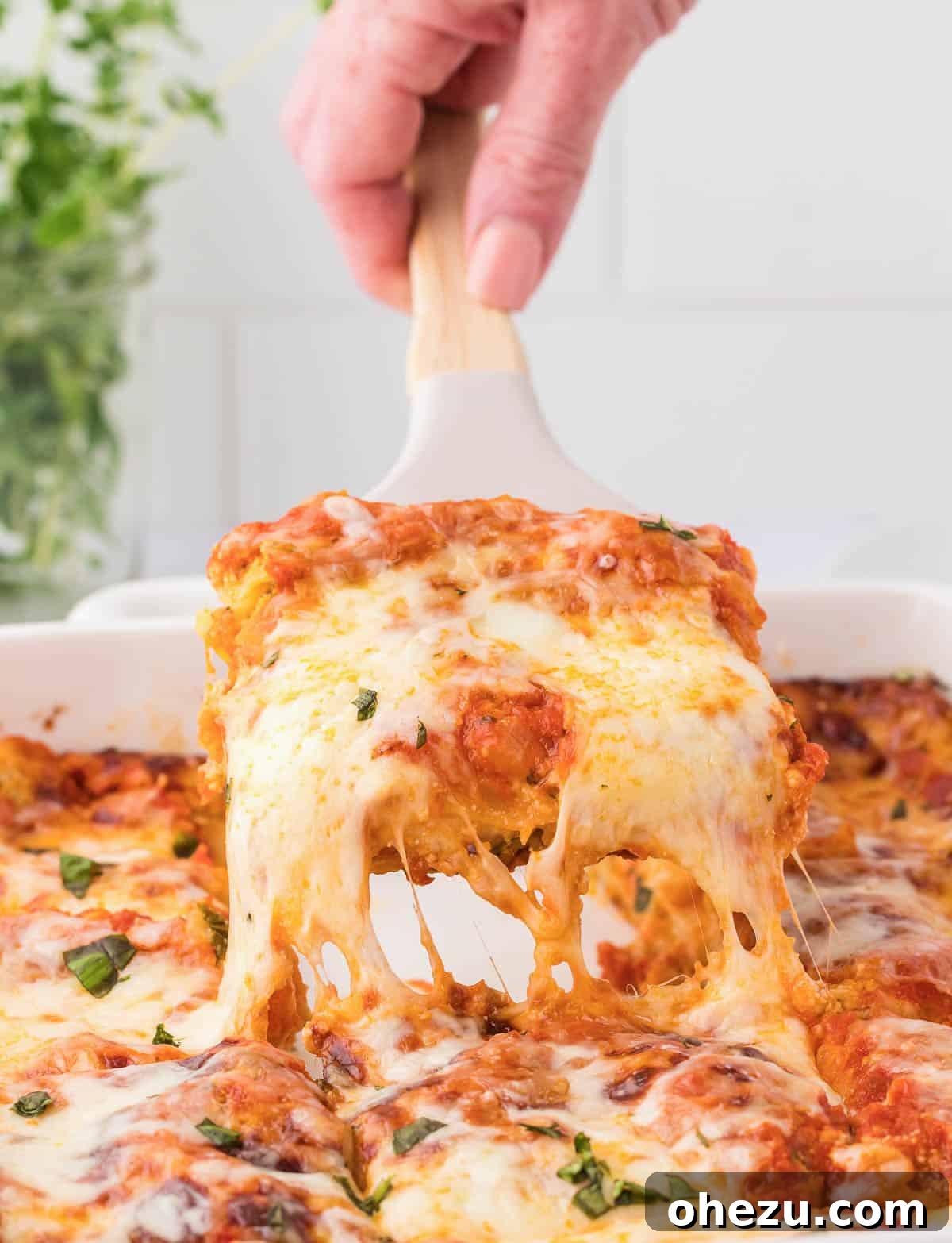Triple Cheese Lasagna 2 A perfectly portioned slice of classic cheese lasagna being lifted from the pan, showing distinct layers of pasta, cheese, and sauce.