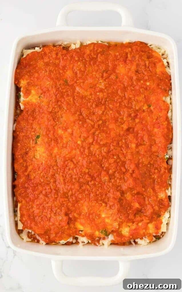 Triple Cheese Lasagna 17 Another layer of pasta sauce covering the ricotta, building depth of flavor.
