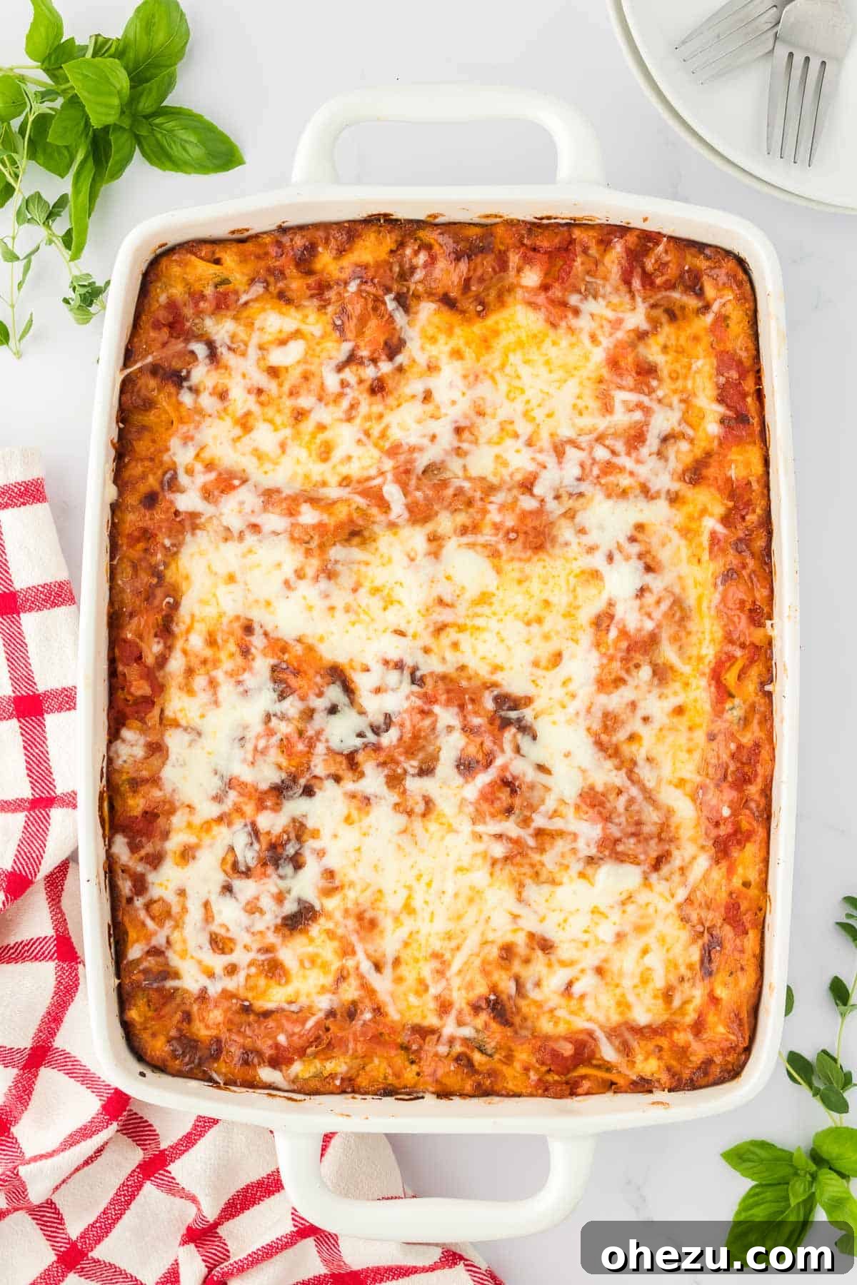 Triple Cheese Lasagna 24 A large baking dish filled with a perfectly baked cheese lasagna, still hot and bubbly from the oven.