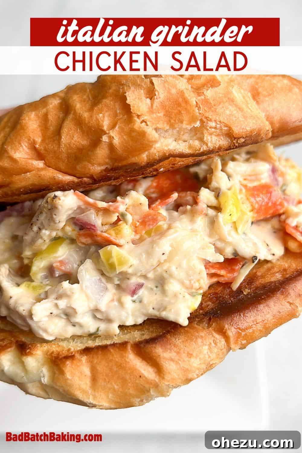 Close-up of a delectable Italian Grinder Chicken Salad served on a toasted croissant.