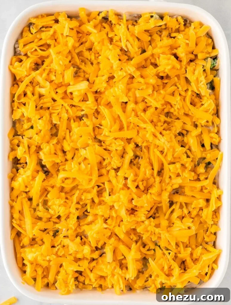 Broccoli casserole topped with a generous layer of cheddar cheese