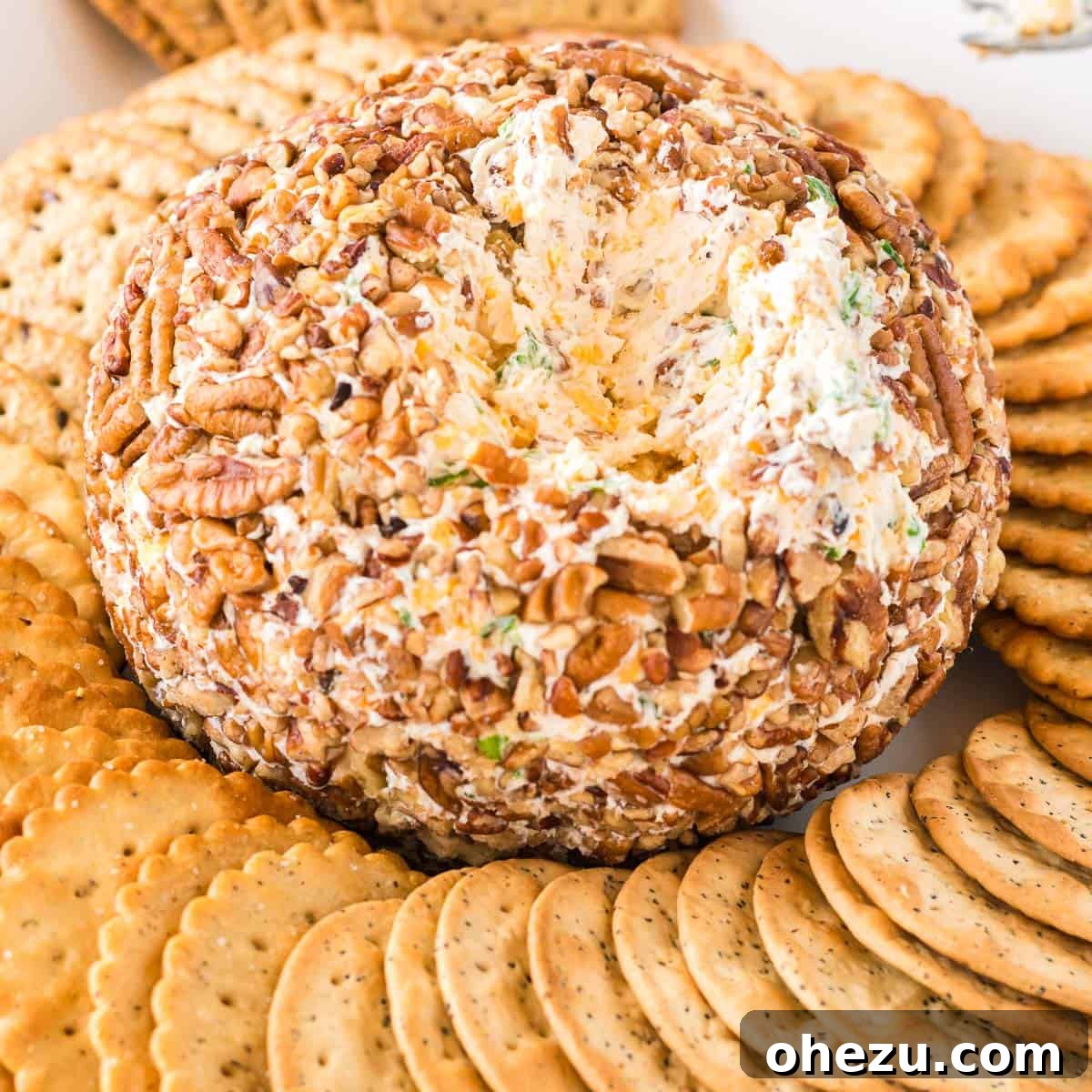 The Ultimate Cheese Ball 13 cheese ball with a chunk missing to show the inside