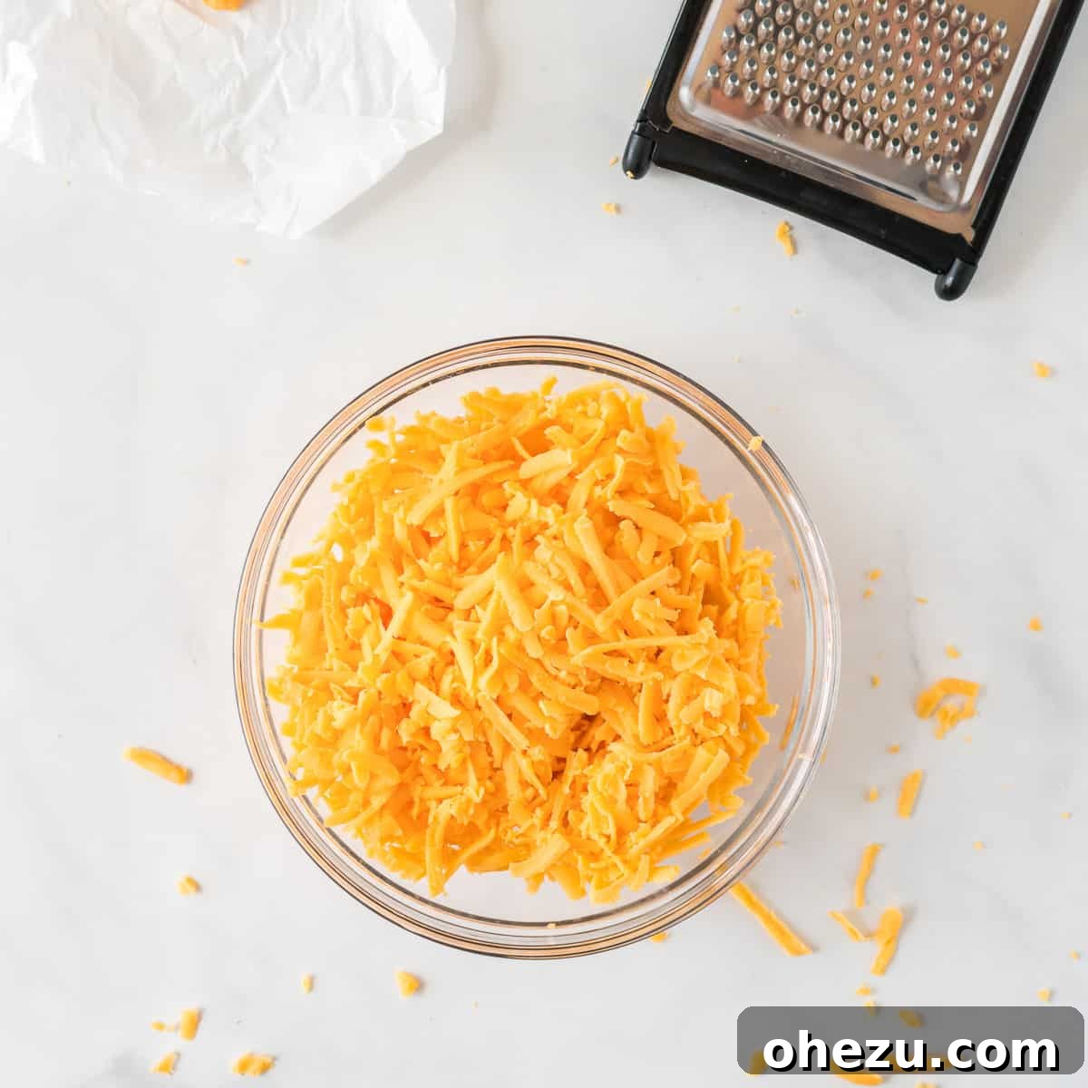 The Ultimate Cheese Ball 7 shredded cheddar cheese in a bowl