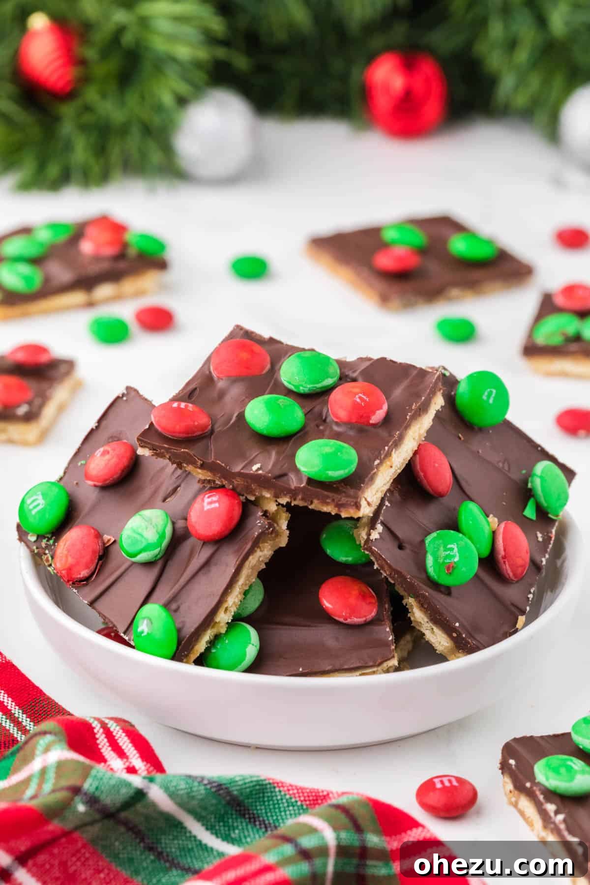 Irresistible Christmas Toffee Bark 14 Assortment of Christmas Crack pieces, some plain and some with toppings, elegantly arranged in a bowl.