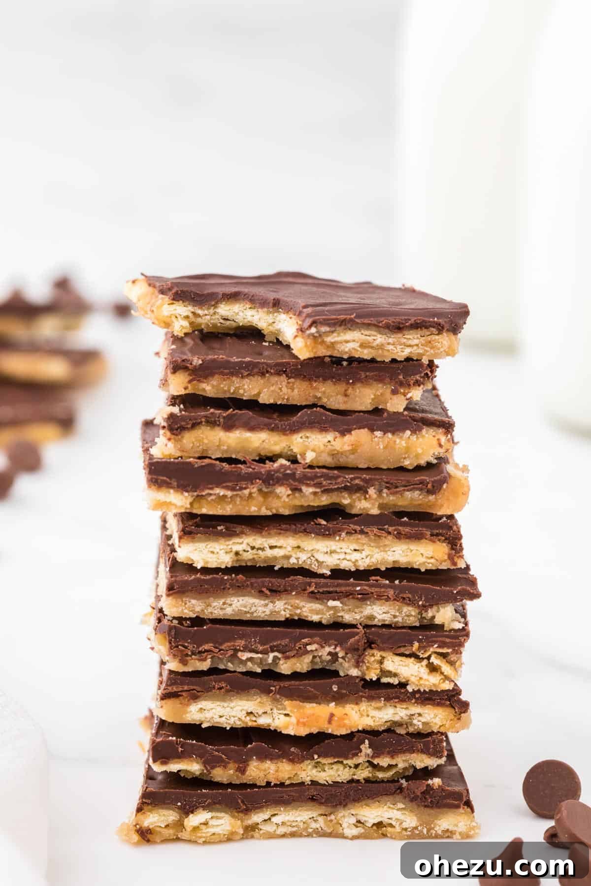 Irresistible Christmas Toffee Bark 15 Stack of plain saltine toffee candy pieces, showcasing the golden toffee and chocolate layers, ready for storage or serving.