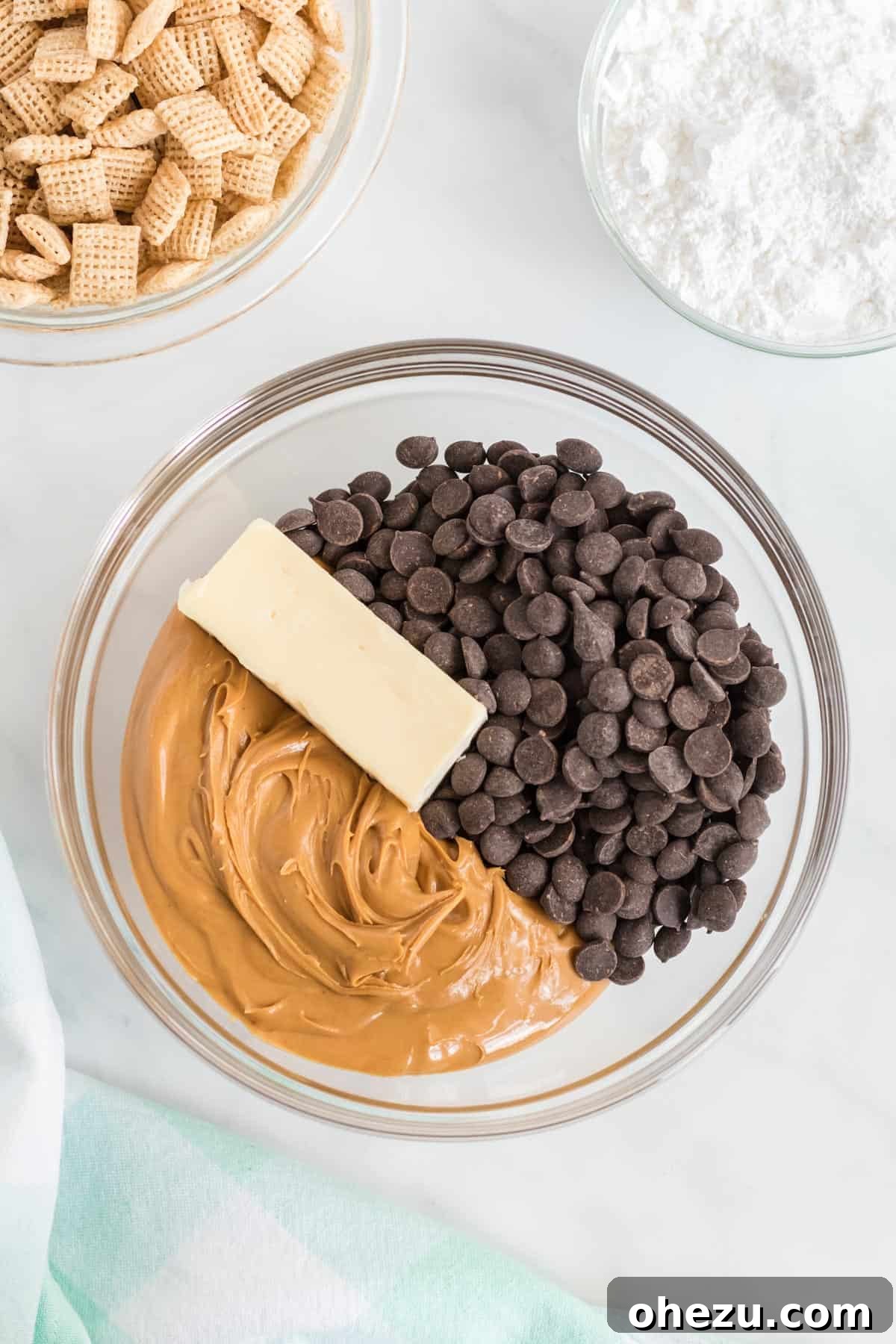 Vegan Chocolate Peanut Butter Cereal Crunch 4 peanut butter, vegan butter, and chocolate chips in a bowl before melting