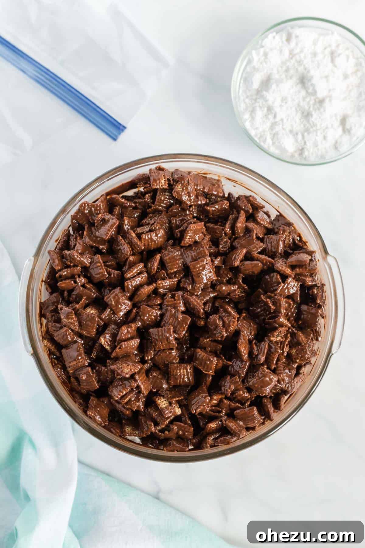 Vegan Chocolate Peanut Butter Cereal Crunch 7 Rice Chex cereal being coated in the melted chocolate and peanut butter mixture in a bowl