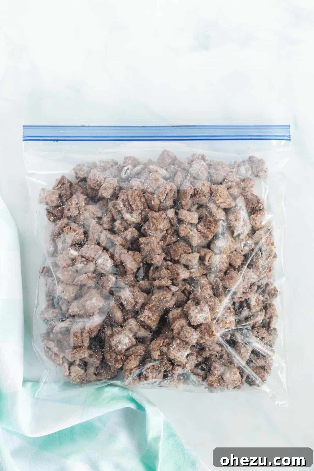 Vegan Chocolate Peanut Butter Cereal Crunch 8 Ziploc bag partially filled with muddy buddies mixture before shaking with powdered sugar