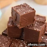 Stack of vegan chocolate peanut butter fudge pieces, perfectly cut and ready for serving.
