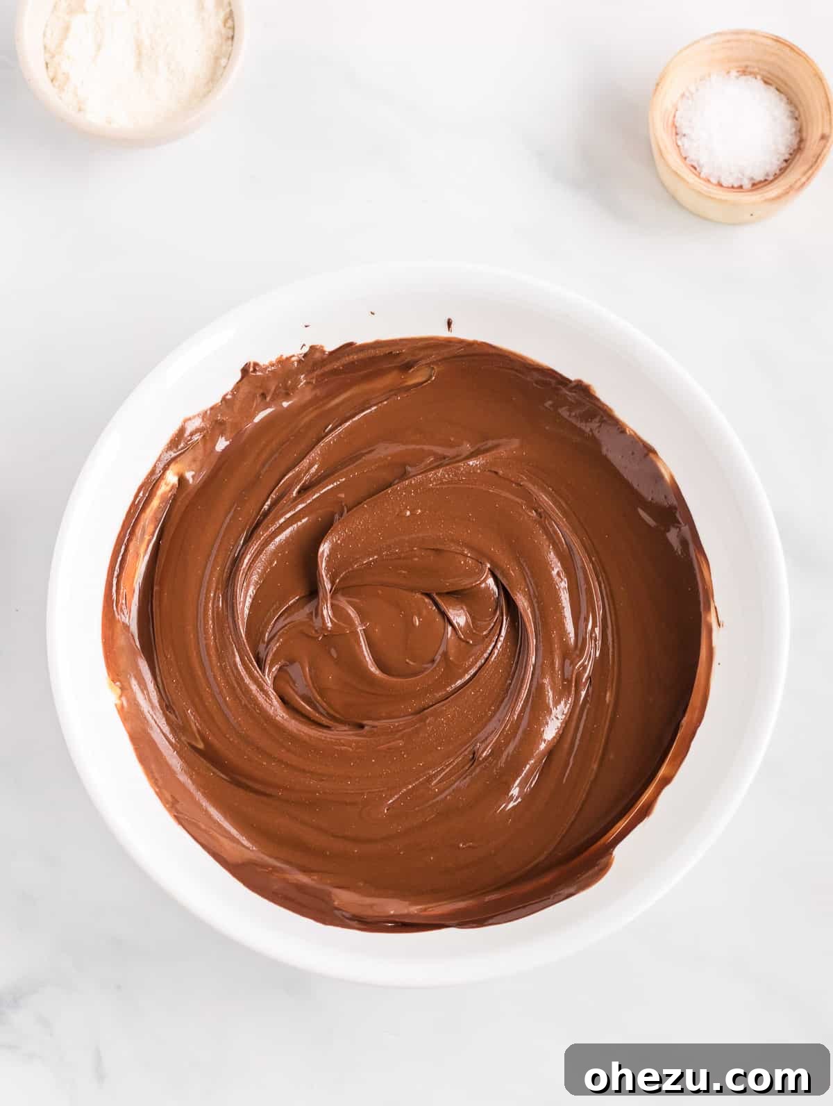 Decadent Vegan Peanut Butter Chocolate Fudge 5 The fully mixed fudge batter, a thick and glossy chocolate peanut butter blend, resting in a glass mixing bowl.