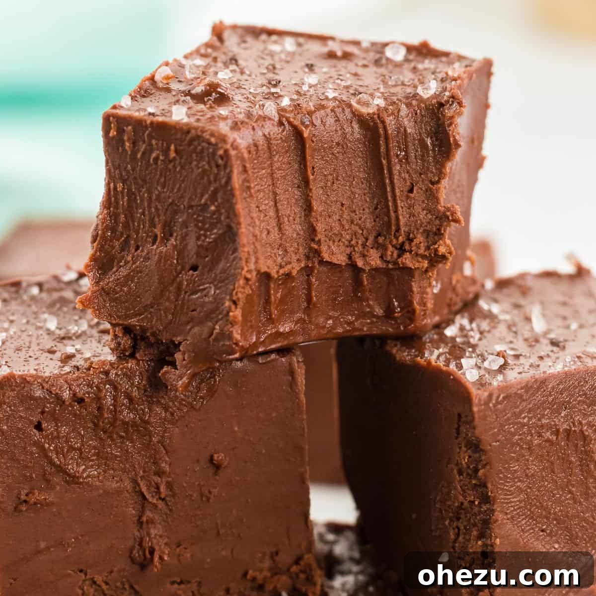Decadent Vegan Peanut Butter Chocolate Fudge 8 A stack of golden brown and dark chocolate vegan fudge squares, showing off their irresistible texture and inviting appearance.
