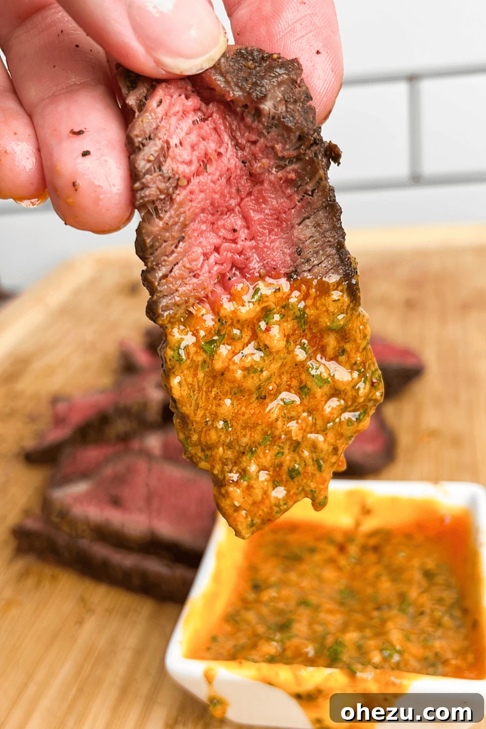 Rustic Herb Butter Steak 2 Slice of perfectly cooked steak dipping into a bowl of rich cowboy butter