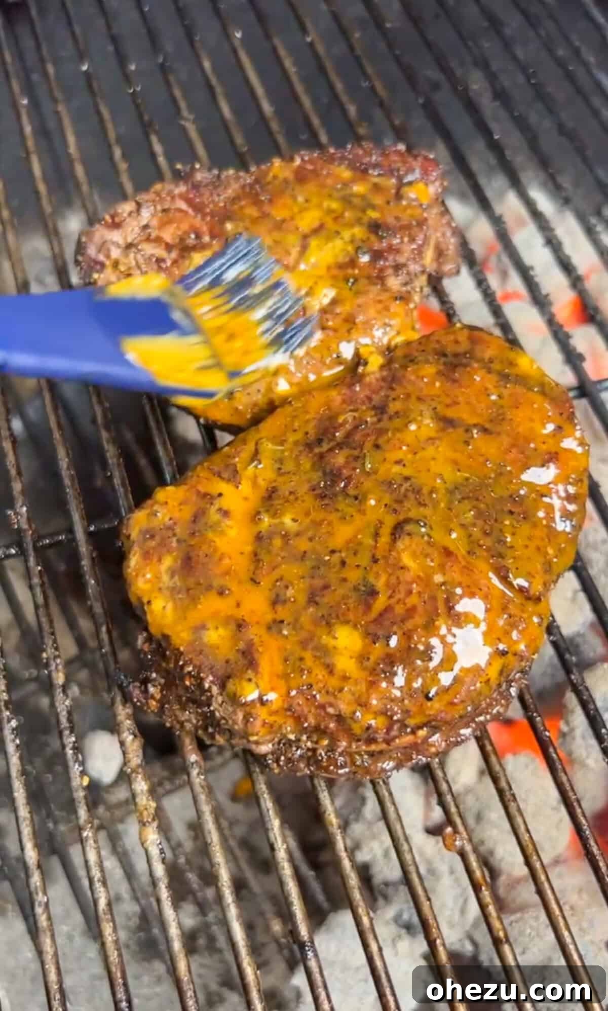 Rustic Herb Butter Steak 7 A sizzling steak being generously smothered with melted cowboy butter on the grill