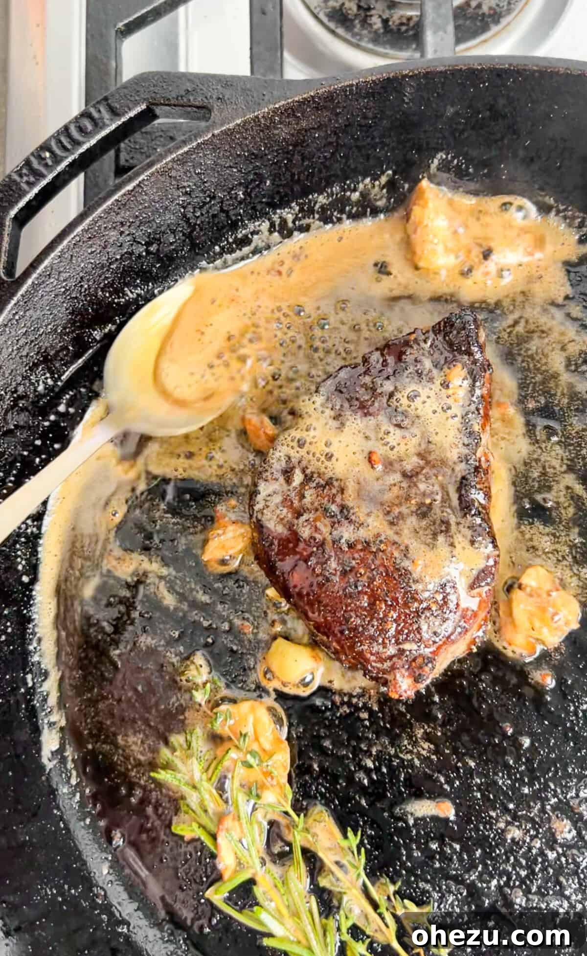 Rustic Herb Butter Steak 10 Sizzling steak in a cast iron skillet, being basted with a generous amount of butter
