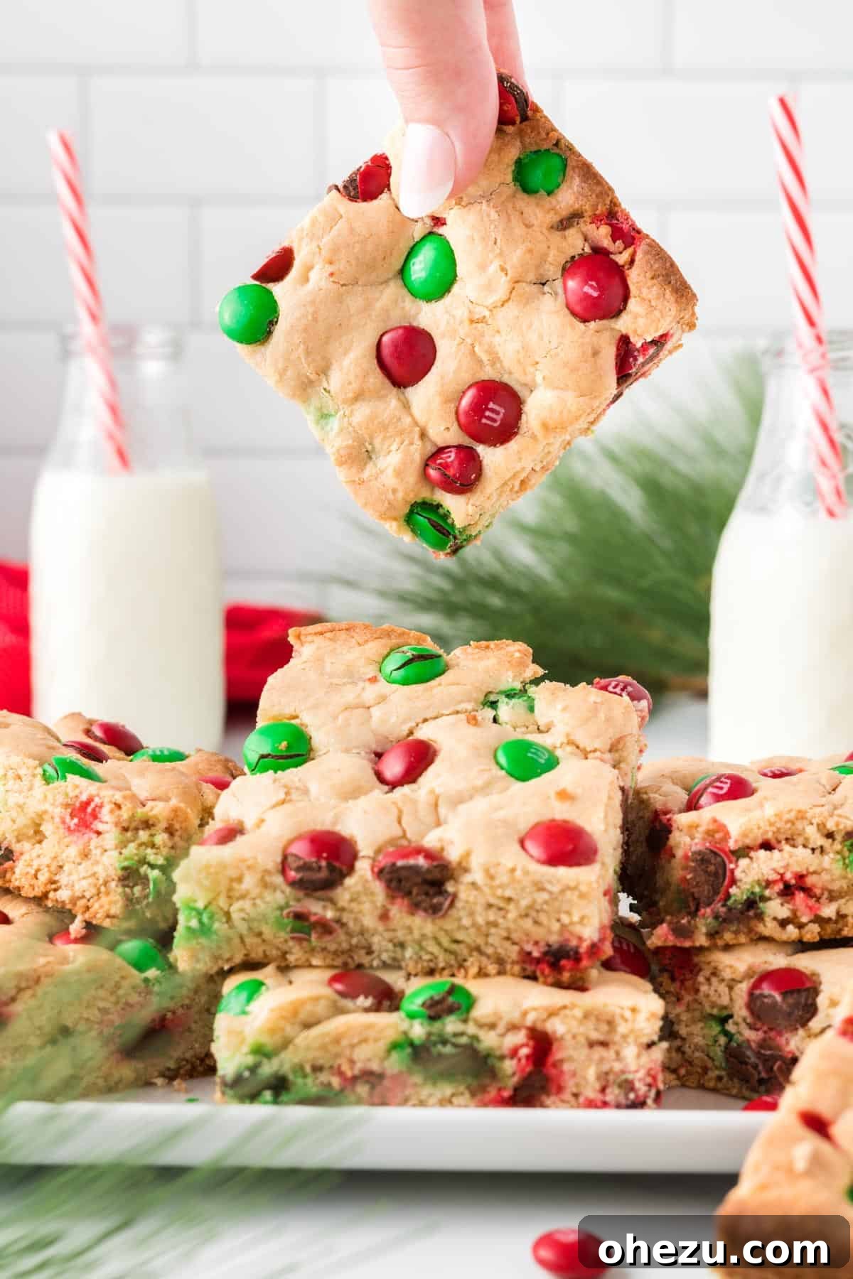 holding a cookie bar above the serving dish