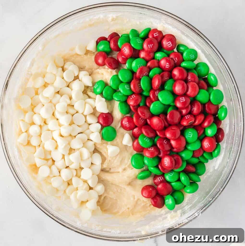 adding m&m's and white chocolate chips to the batter