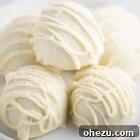 white chocolate balls stacked on a white plate