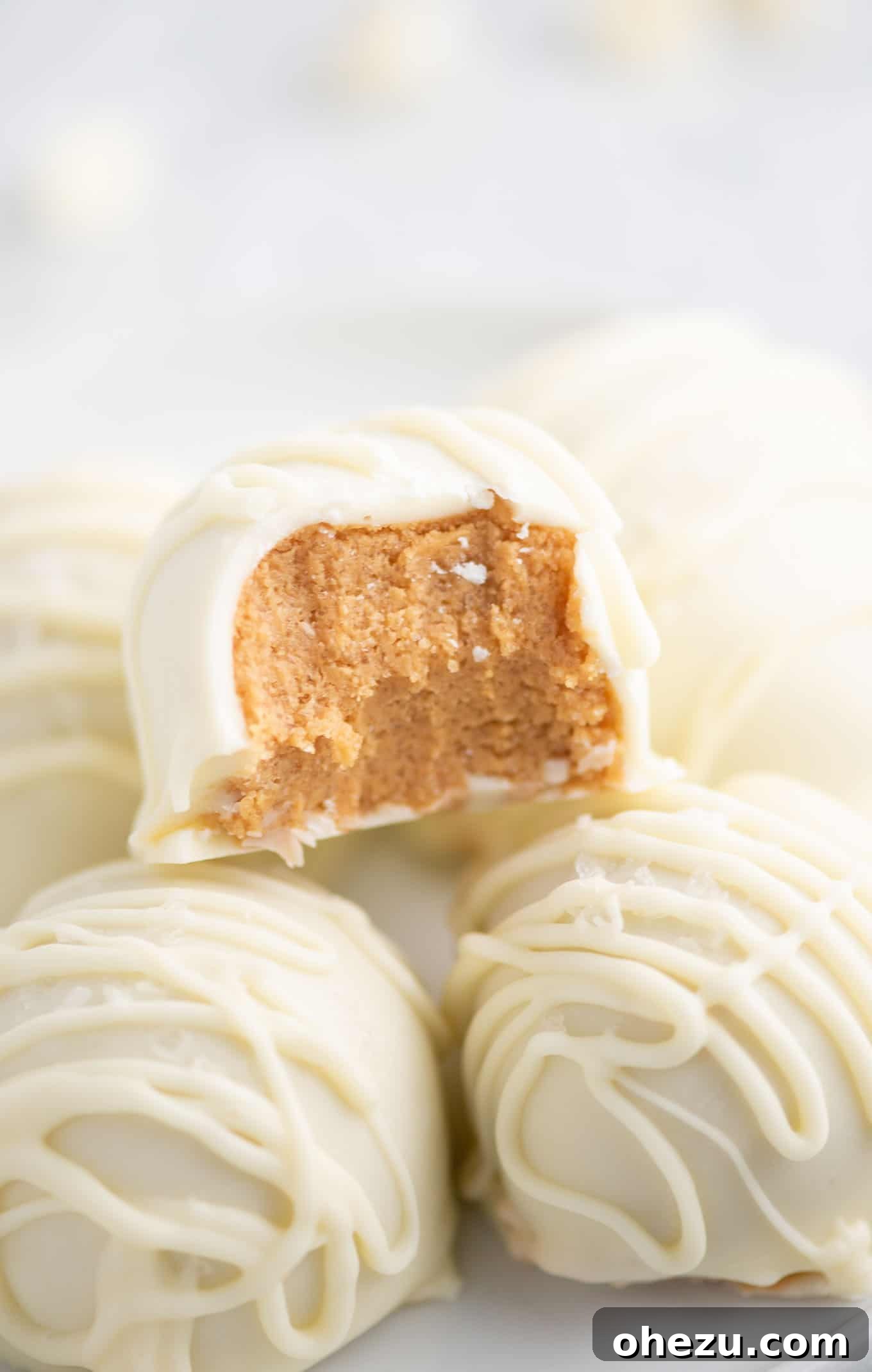 No-Bake White Chocolate Peanut Butter Delights 4 white chocolate peanut butter ball with a bite taken out