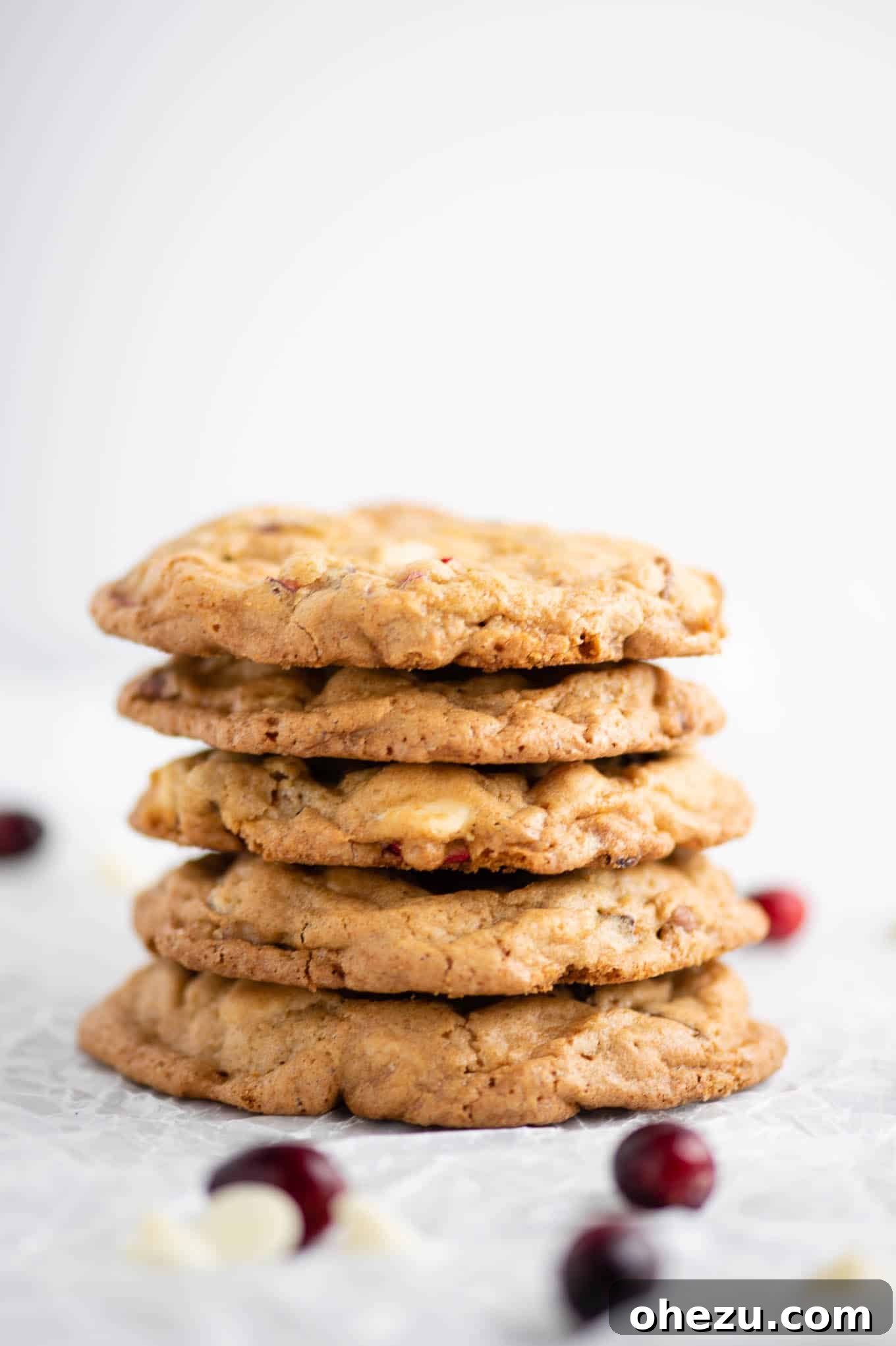Decadent White Chocolate Cranberry Pecan Cookies 8 Up close view of stacked white chocolate cranberry pecan cookies, highlighting their texture and ingredients