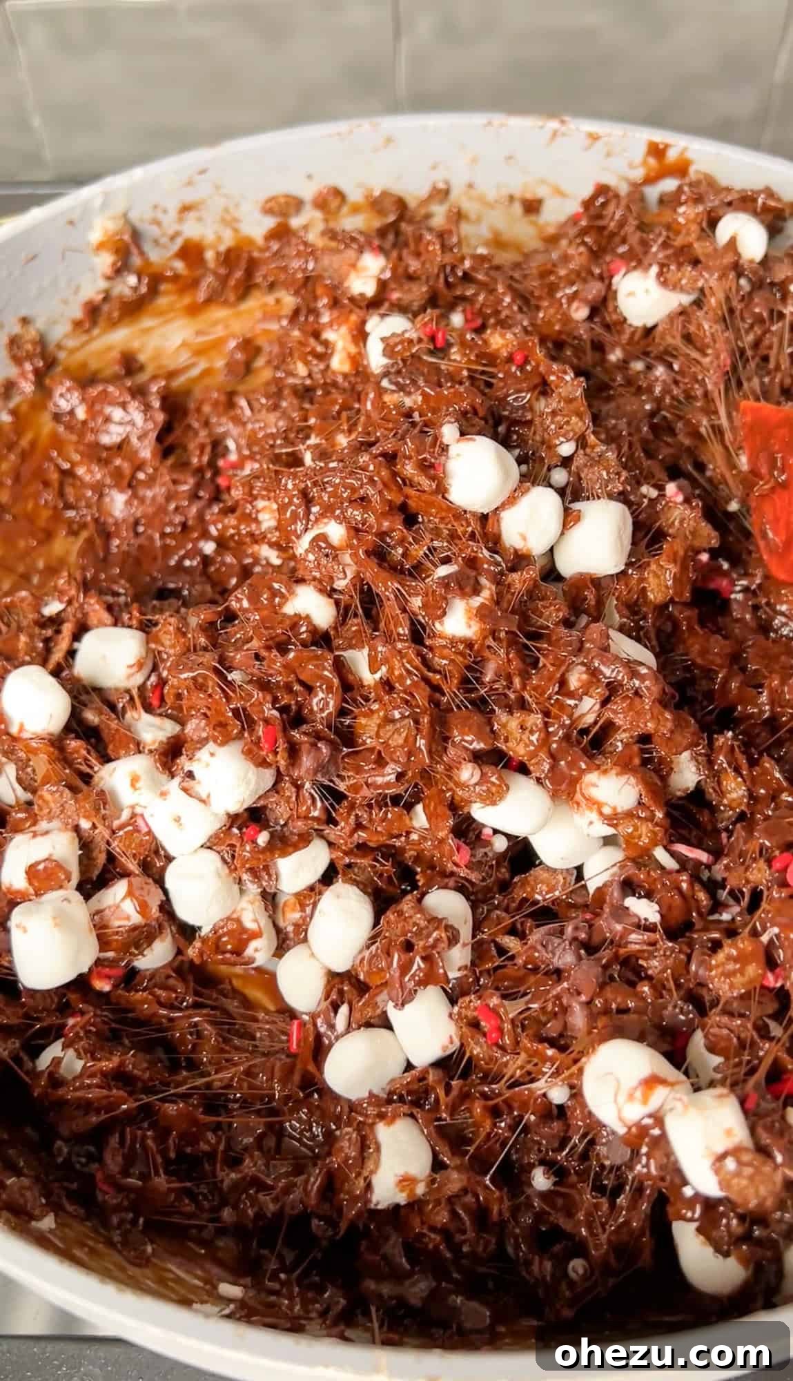 Cozy Cocoa Crisps 11 The fully mixed Hot Cocoa Rice Krispie Treat mixture, thick and gooey, sitting in the large nonstick pan before being transferred.