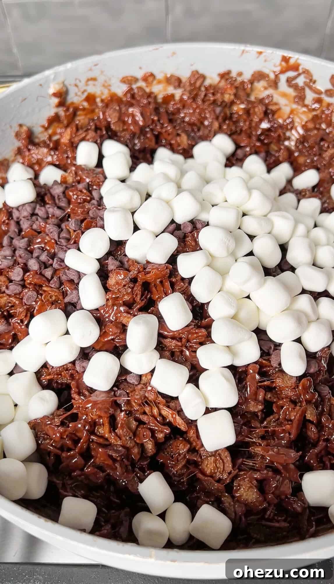 Cozy Cocoa Crisps 10 Additional mini marshmallows stirred into the cereal and chocolate-marshmallow mixture, creating delightful pockets and swirls.