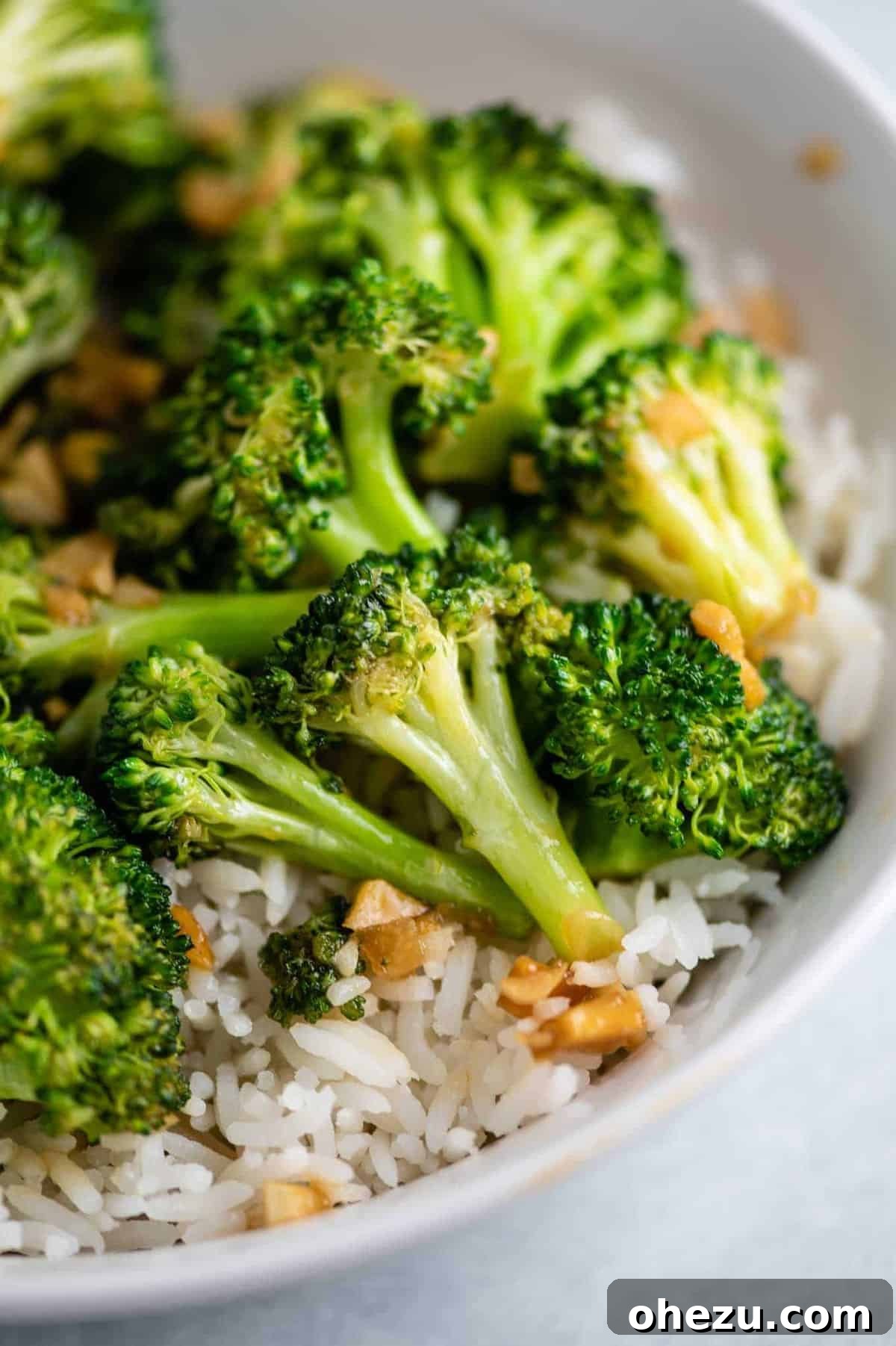 Crisp and Flavorful Broccoli Stir Fry 2 broccoli stir fry over rice in a white bowl