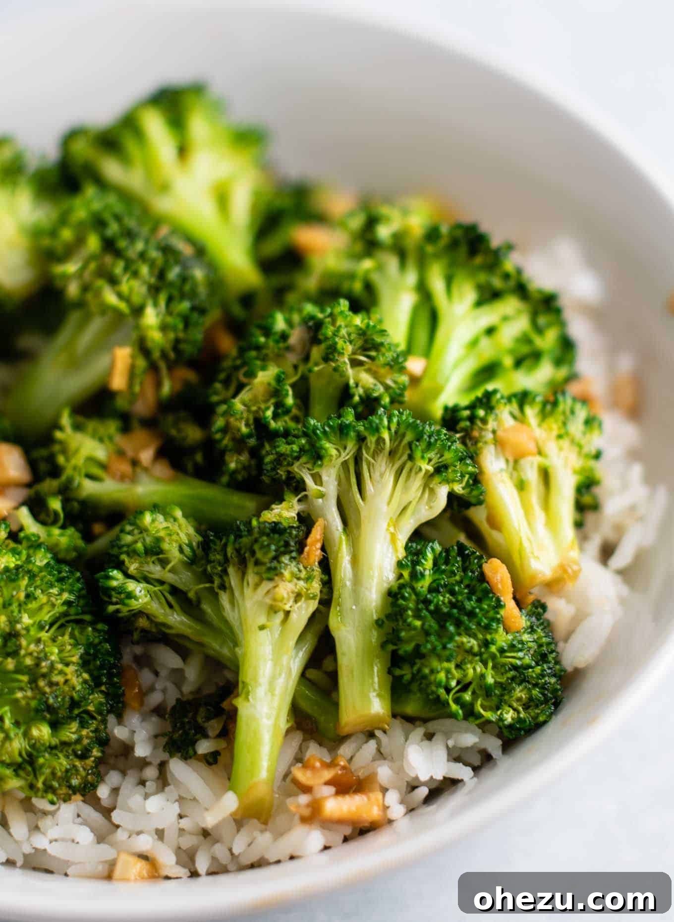 Crisp and Flavorful Broccoli Stir Fry 3 broccoli over rice in a white bowl